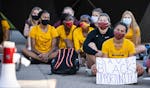 U student athletes staged a sit-in to protest sports programs being cut outside the McNamara Alumni Center on the University of Minnesota campus. ] LE