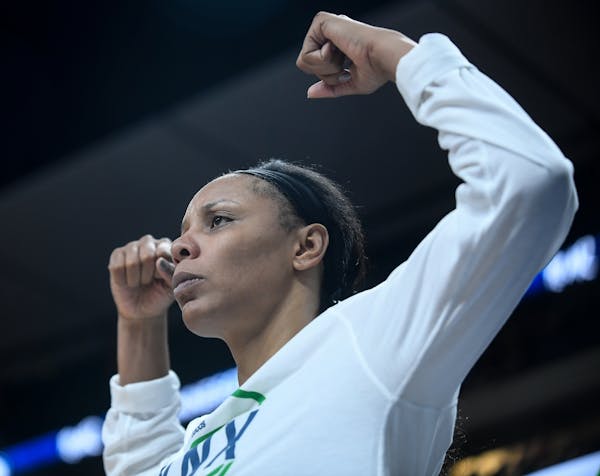 Minnesota Lynx forward Plenette Pierson (22) flexed her muscles to celebrate an and-one opportunity created by center Sylvia Fowles (34) in the third 