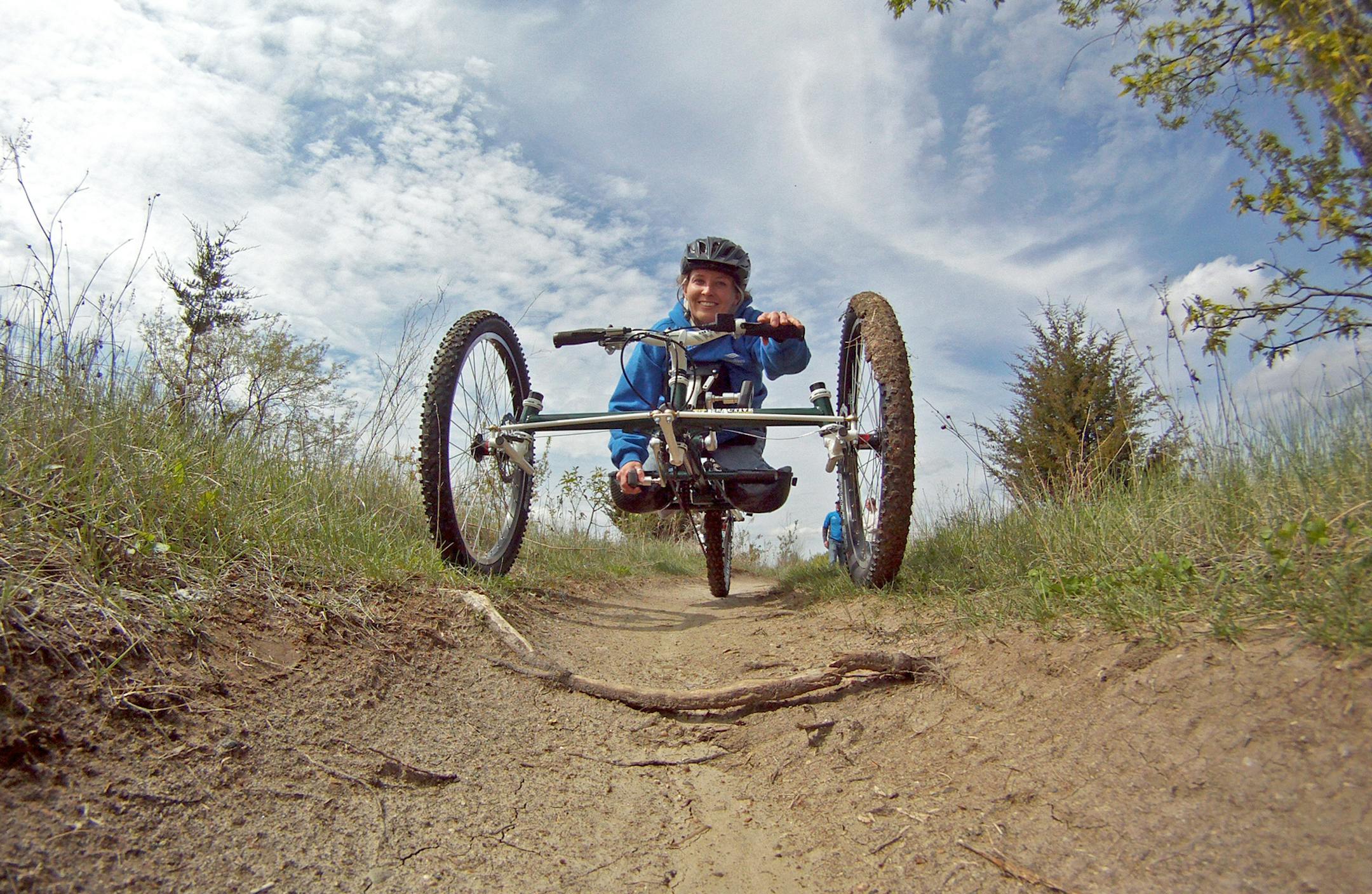 Three Rivers Park District photo by Derek J. Dickinson / Tracy Tabaka, an adaptive recreation specialist at Three Rivers Park District, demonstrates the use of an off-road handcycle for adaptive mountain biking. Tabaka and her husband, Sam, lead the adaptive programs, which include kayaking, archery, geocaching and ice fishing.