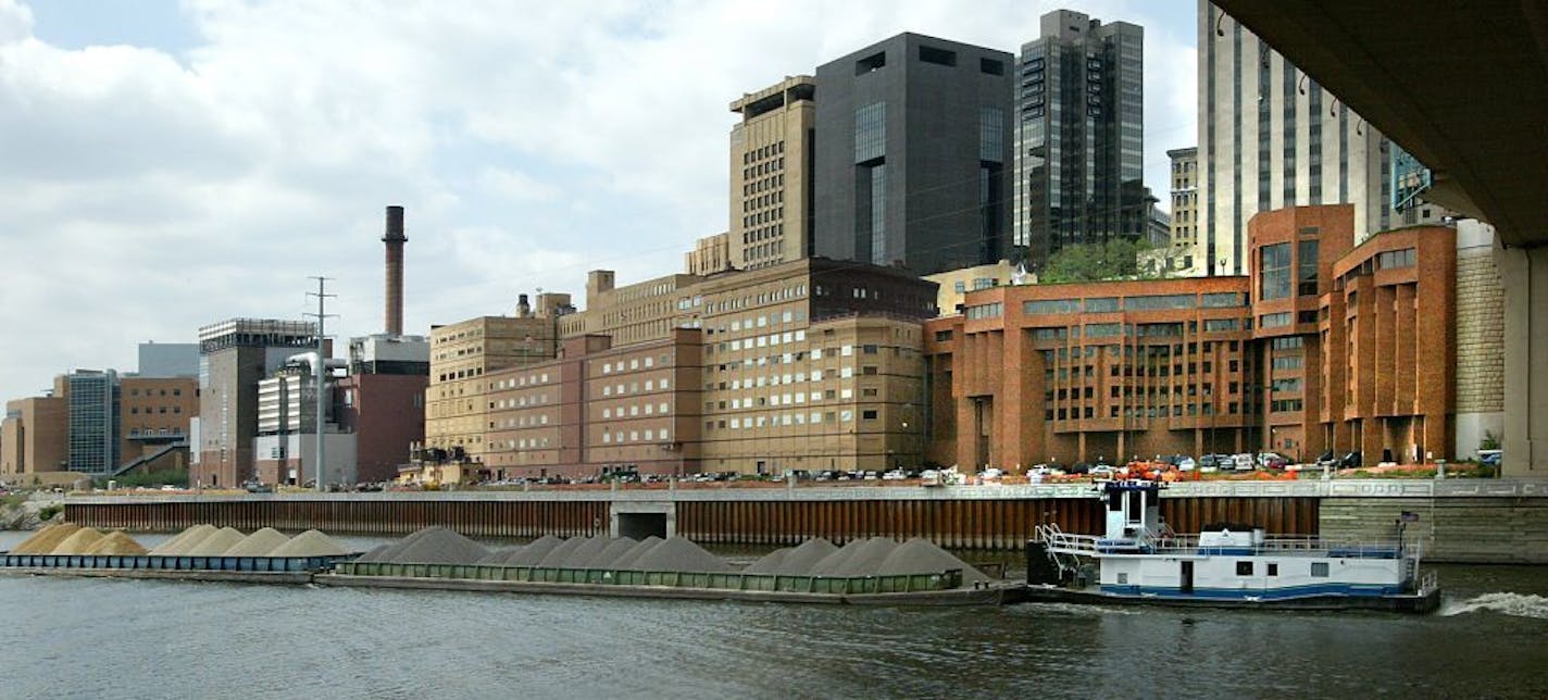 Some of the St. Paul riverfront, seen from the south side of the Mississippi River and under the new Wabasha Street Bridge. (Similar to historical viewpoint pic) -- GENERAL INFORMATION: ST PAUL, MN - 8/21/2003 - THUR - Ramsey County will put its jail & part of the nearby government West Building up for sale as early as next week. They hope to attract developers interested in converting the reinforced steel building into a waterfront gem. Looking for photos of the building from the bridge or the