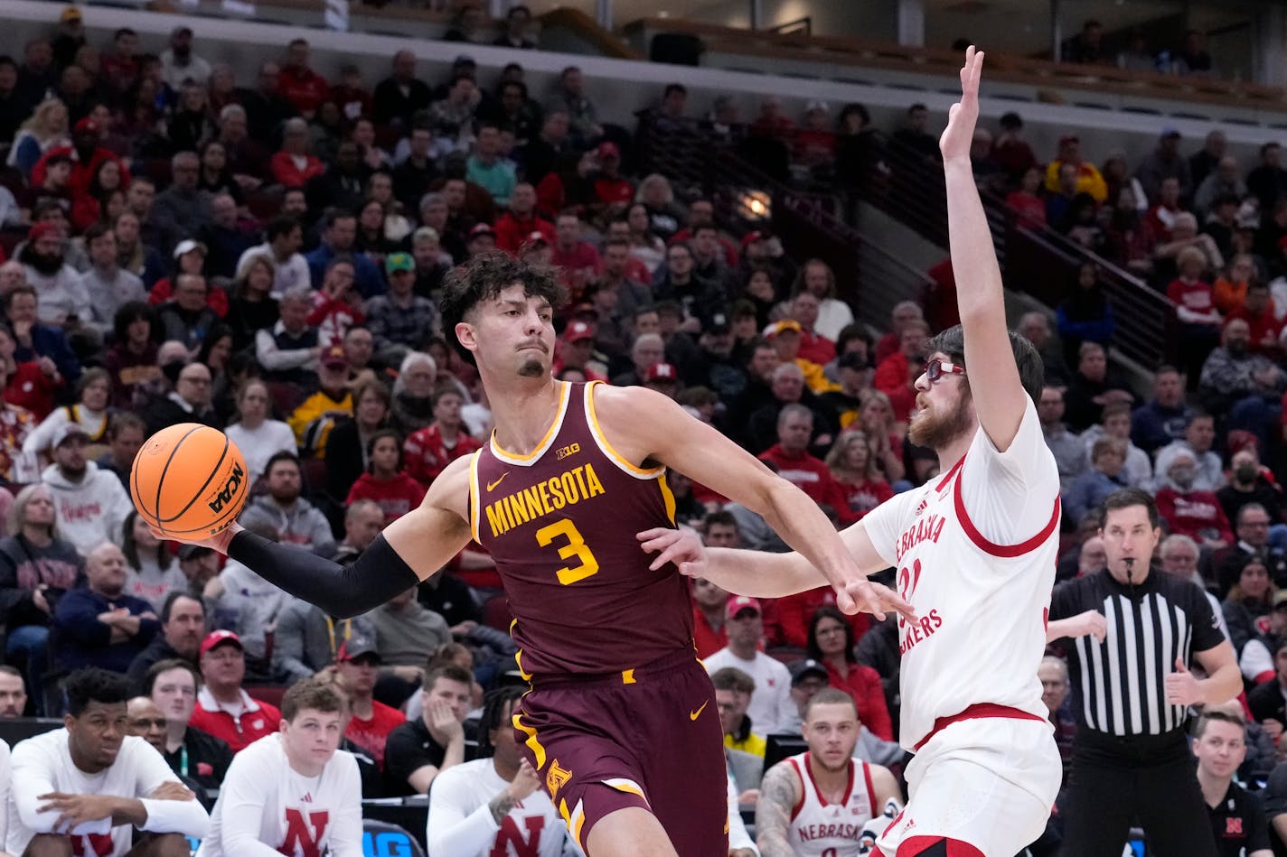 Minnesota's Dawson Garcia looks to pass as Nebraska's Wilhelm Breidenbach defends during the first half Wednesday at the Big Ten men's basketball tournament.