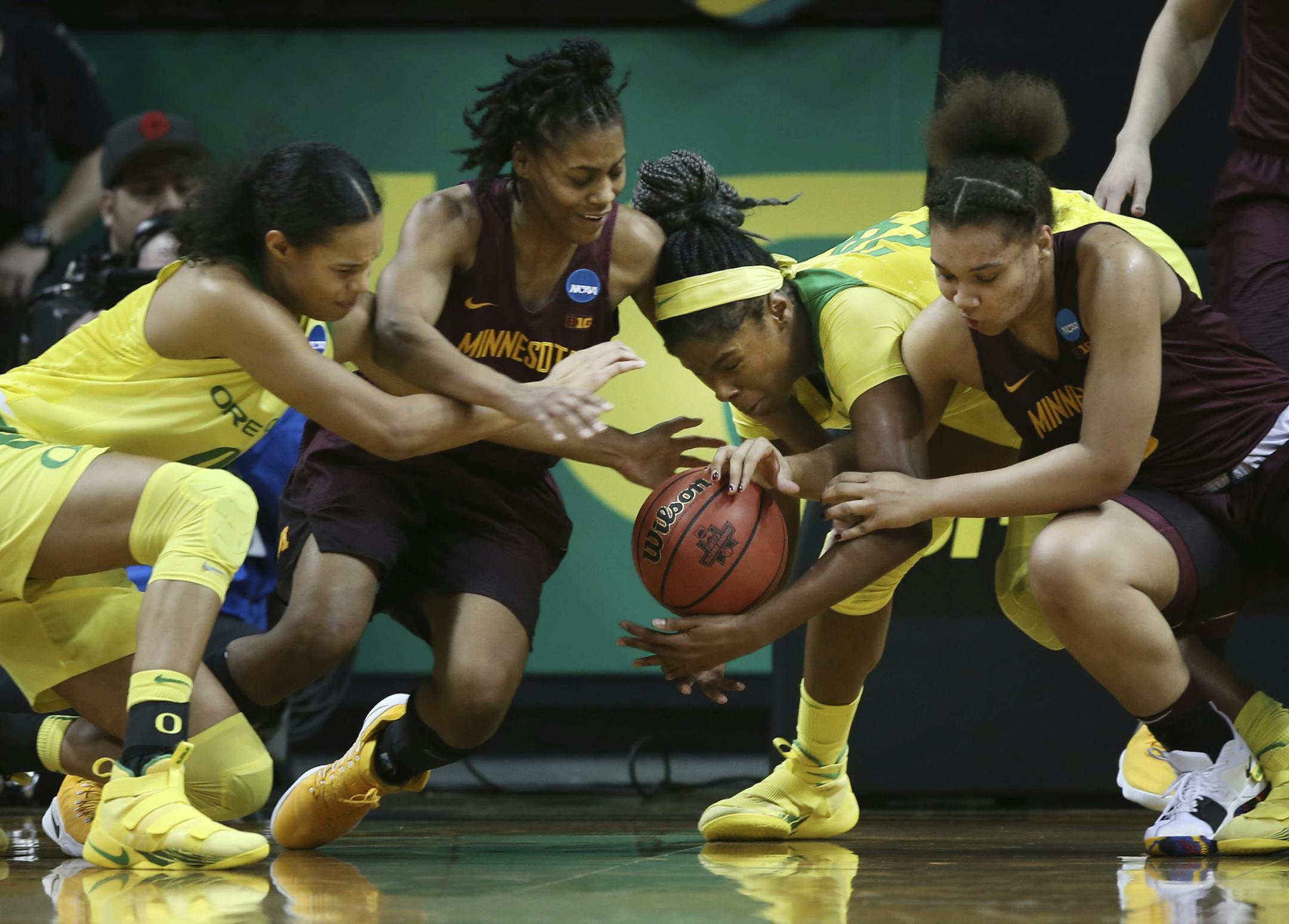 Oregon's Satou Sabally, left, Minnesota's Kenisha Bell, center left, Oregon's Ruthy Hebard and Minnesota's Destiny Pitts, right, scramble for a loose ball during the first half of their second-round game in the NCAA women's college basketball tournament in Eugene, Ore., Sunday, March 18, 2018. (AP Photo/Chris Pietsch)