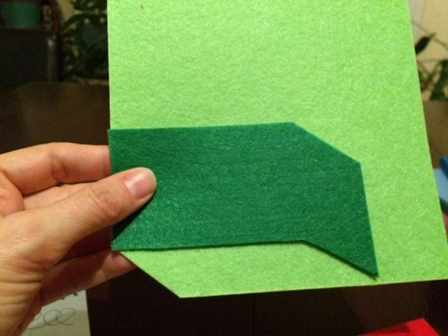 Part of step-by-step instructions for crafting a felt dumpster fire holiday ornament.