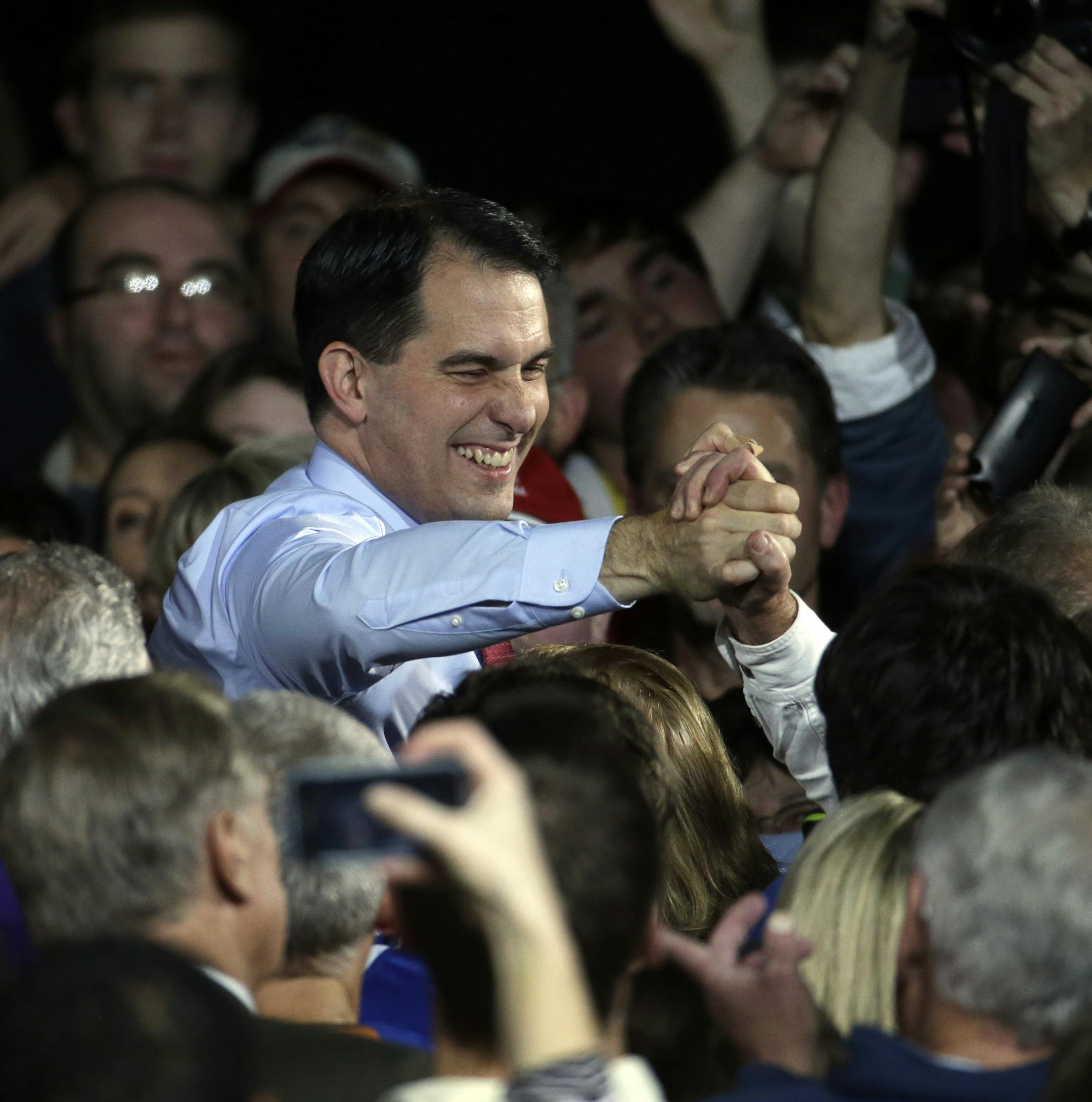 Wisconsin Republican Gov. Scott Walker shakes hands after speaking at his campaign party Tuesday, Nov. 4, 2014, in West Allis, Wis. Walker defeated Democratic gubernatorial challenger Mary Burke. (AP Photo/Morry Gash)