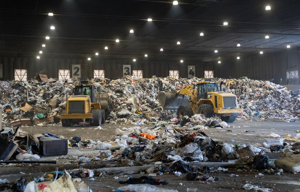 Piles of trash were collected and sorted on the main tipping floor at the Ramsey/Washington Recycling & Energy Center in Newport.