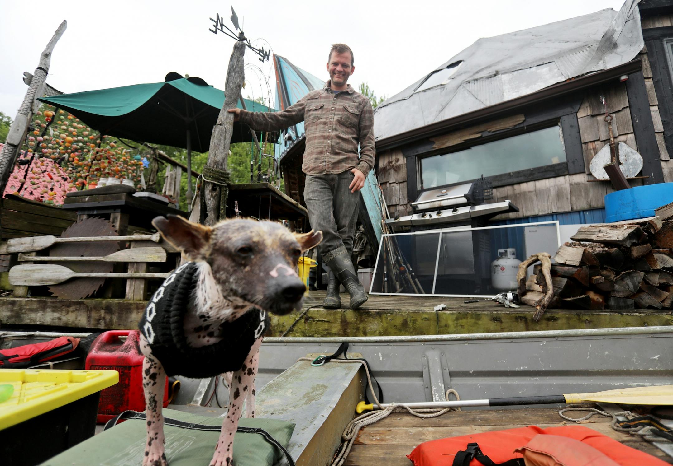 Gerty Tonjum and his rescue dog from Puerto Rico watched as Moses Simon pulled in for a visit on the Mississippi River.
