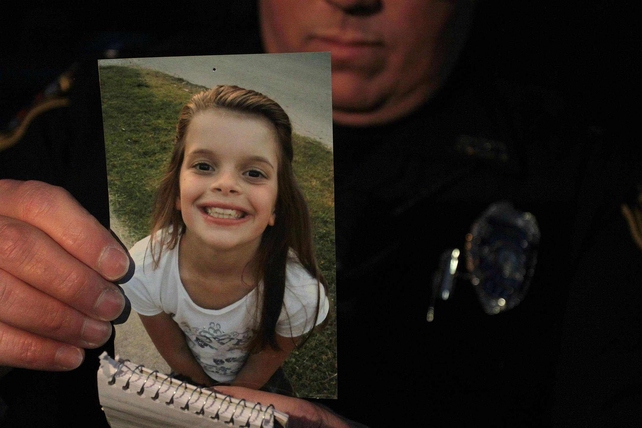 Lt. Robert Pitts holds the photo of Hailey Owens, 10, on Tuesday, Feb. 19, 2014 in Springfield, Mo. Woods was charged Wednesday with first-degree murder in the death of a 10-year-old girl. A body believed to be that of Hailey Owens was found Wednesday at the home owned by Wood, Police Chief Paul Williams said at a news conference. Official confirmation won't occur until after an autopsy, but Police Chief Paul Williams said "we have a high degree of confidence" in the preliminary identification.
