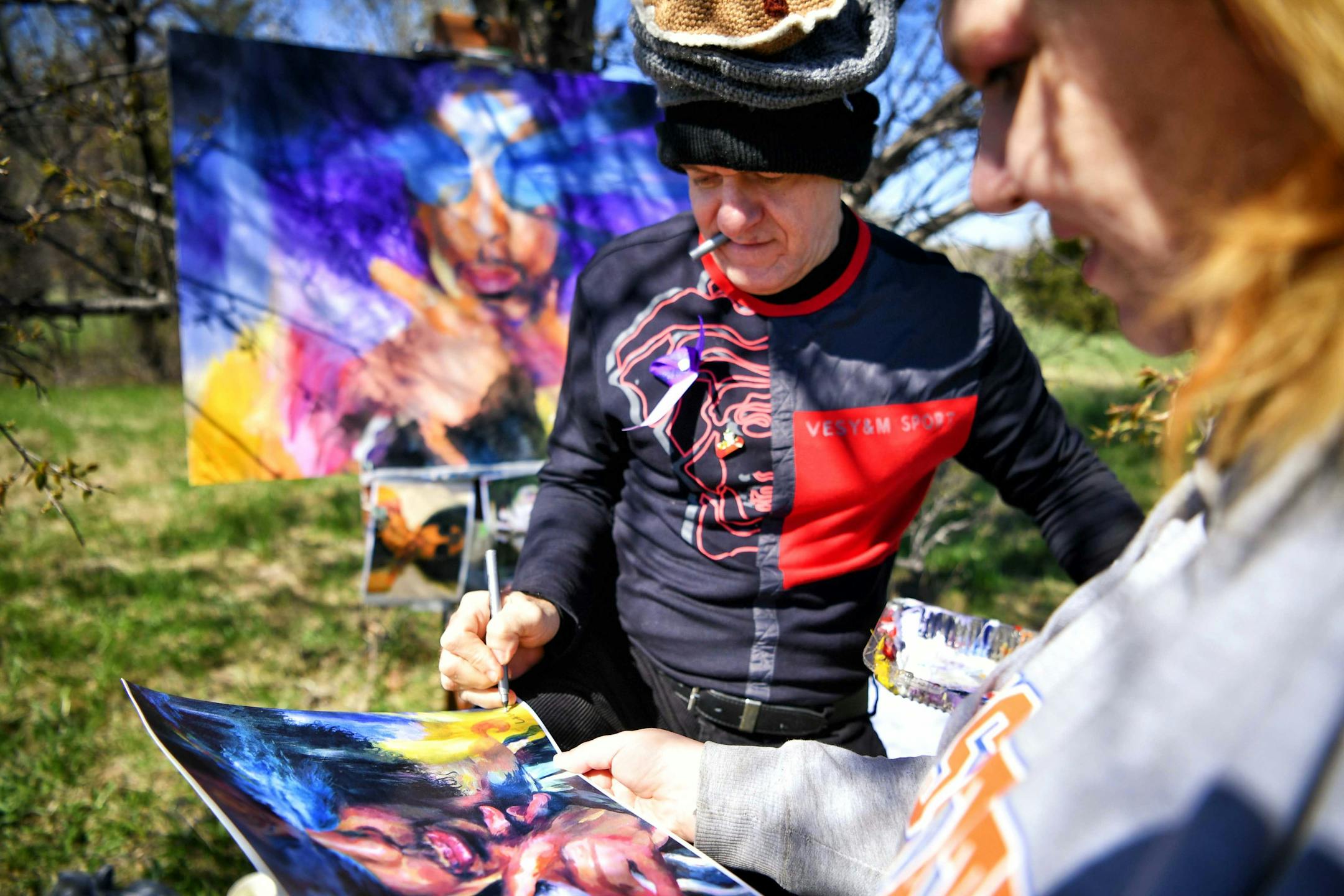 Dan Lacey signed a print for Melissa Weth from Fridley, MN. Dan also known as "Painter of Pancakes" didn't charge for his prints outside Paisley Park. ] GLEN STUBBE • glen.stubbe@startribune.com Friday, April 21 2017 Fans came to Prince's Paisley Park on the first anniversary of his death.