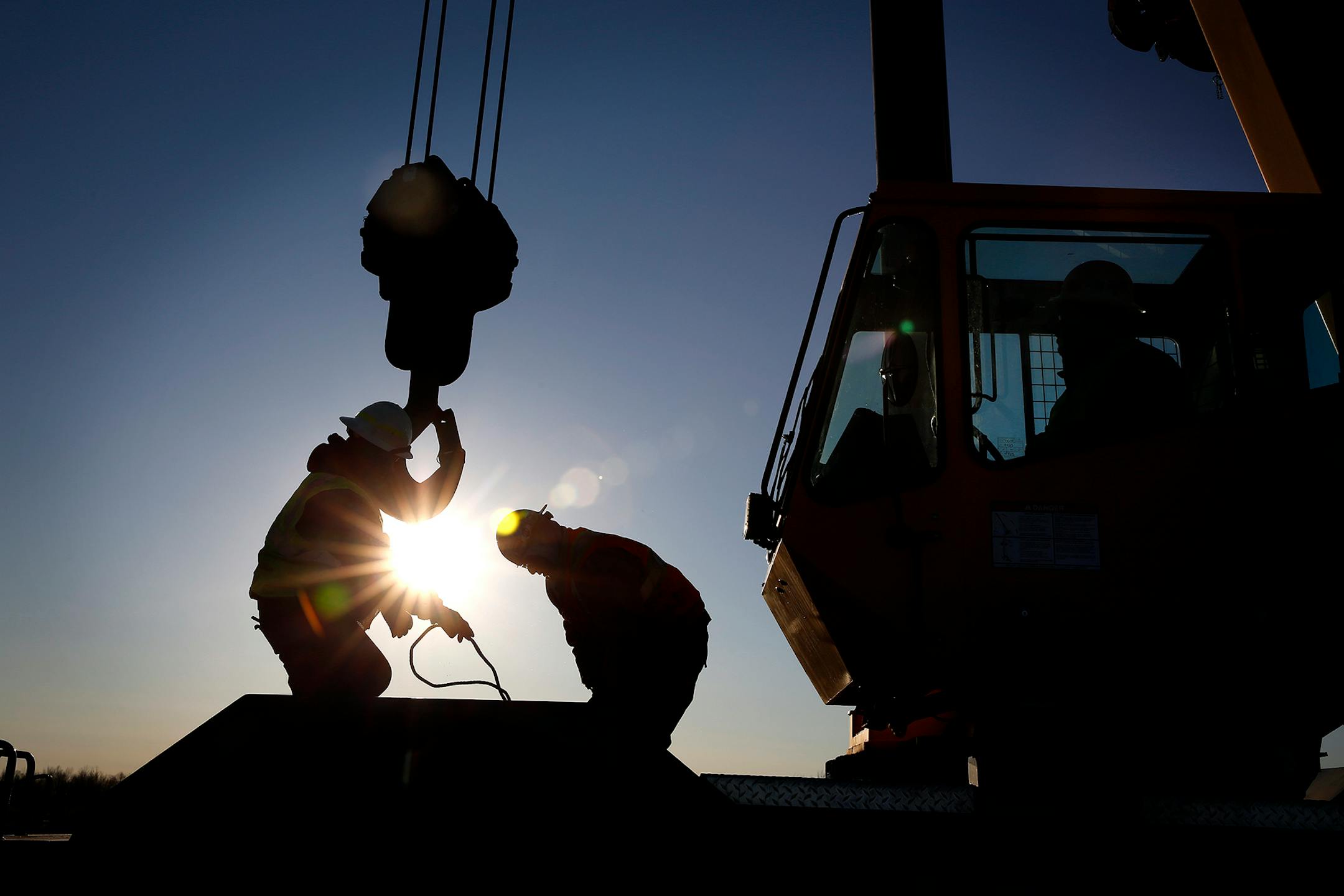 Iron workers set up a crane to move steel for the construction of buildings on the site of the taconite mine project in Nashwauk, Minn.