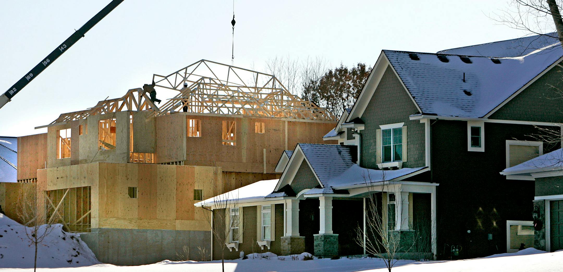 Workers build a home in the Pinehurst neighborhood of Chanhassen on Lake Harrison Circle.