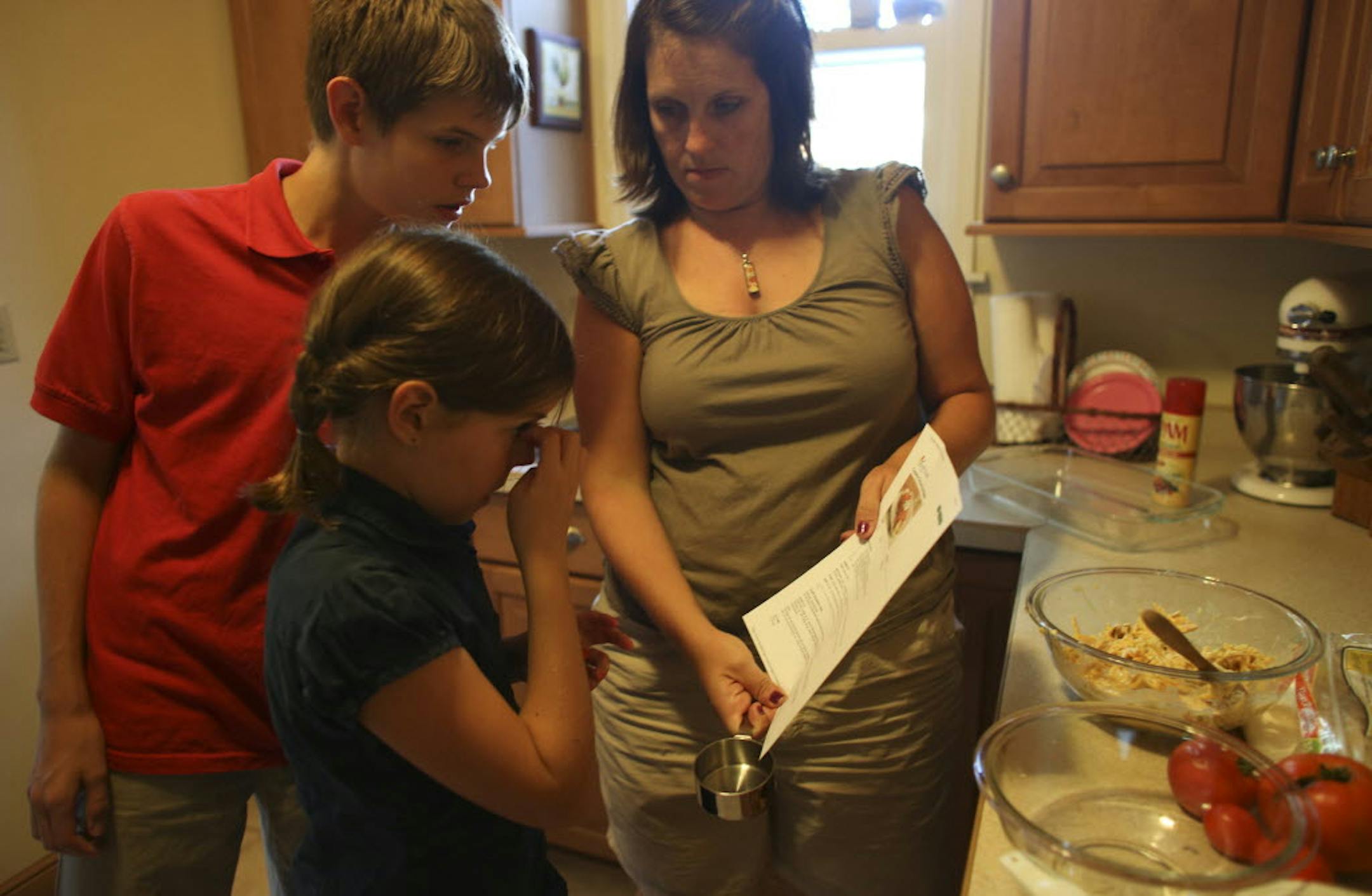 Sara Carson went over an enchilada recipe with son Noah, 14, and daughter Josephine, 10, as everyone in the Richfield family participated in dinnertime.
