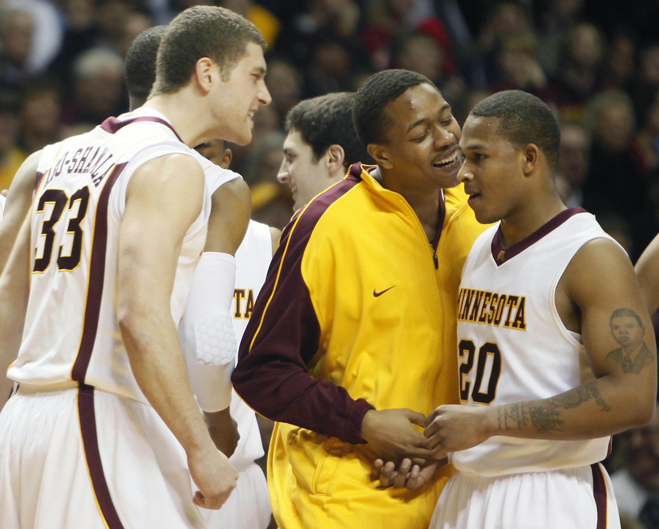 Richard Tsong-Taatarii/rtsong-taatarii@startribune.com Minneapolis, MN;3/4/09; At Williams Arena, in a game between the Gophers and the Badgers, Jamal Abu-Shamala, and Devron Bostick congratulate Lawrence Westbrook for sealing the game for the Gophers.