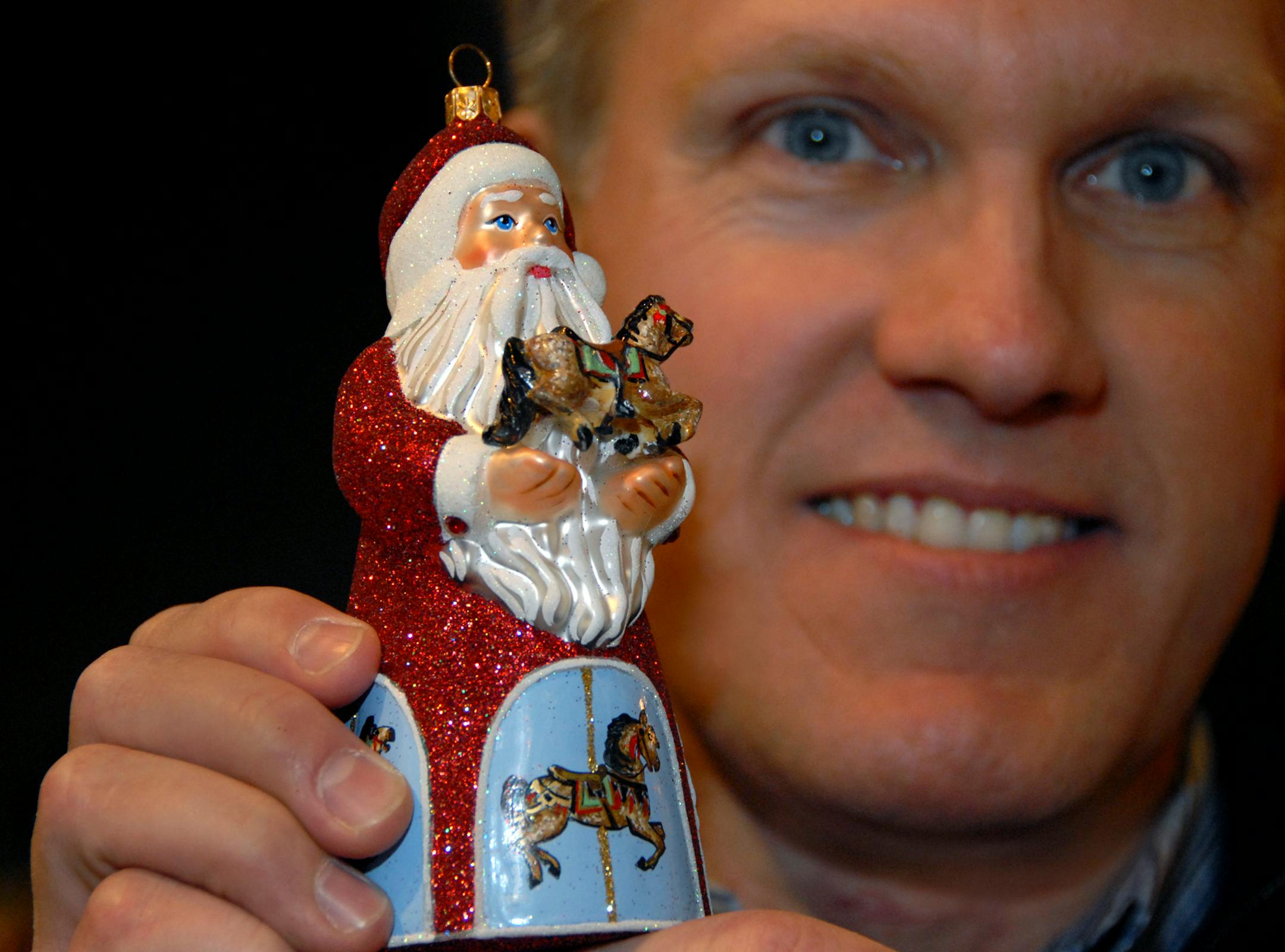 Ornament designer David Strand held his best selling Santa ornament, "Carousel Santa". The inspiration for the carousel horses was Cafesjian's Carousel, he said.