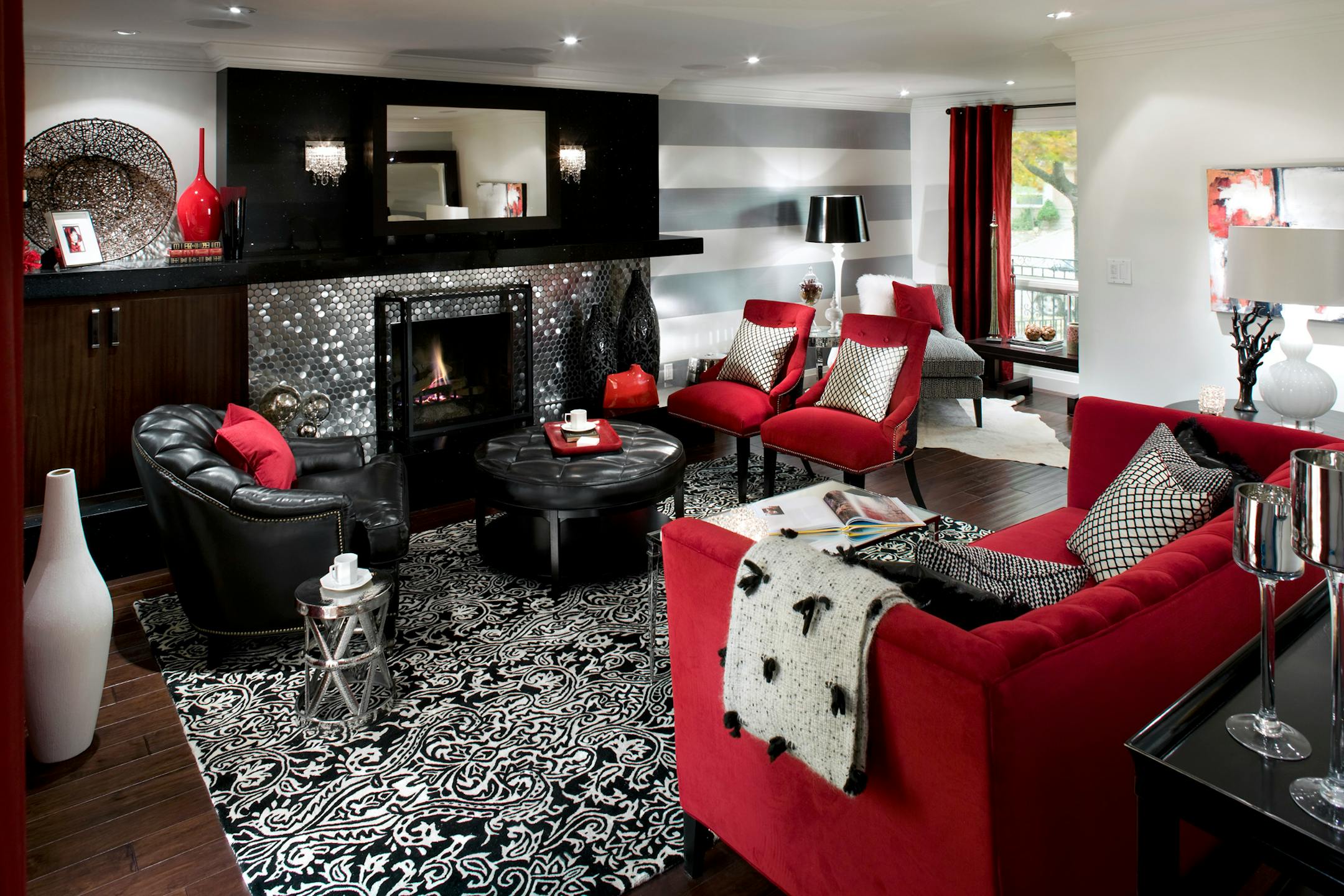 With vivid colors, funky fabrics, a fantastic focal point and some out-of-this-world lighting, this room is now modern, sleek and sophisticated.