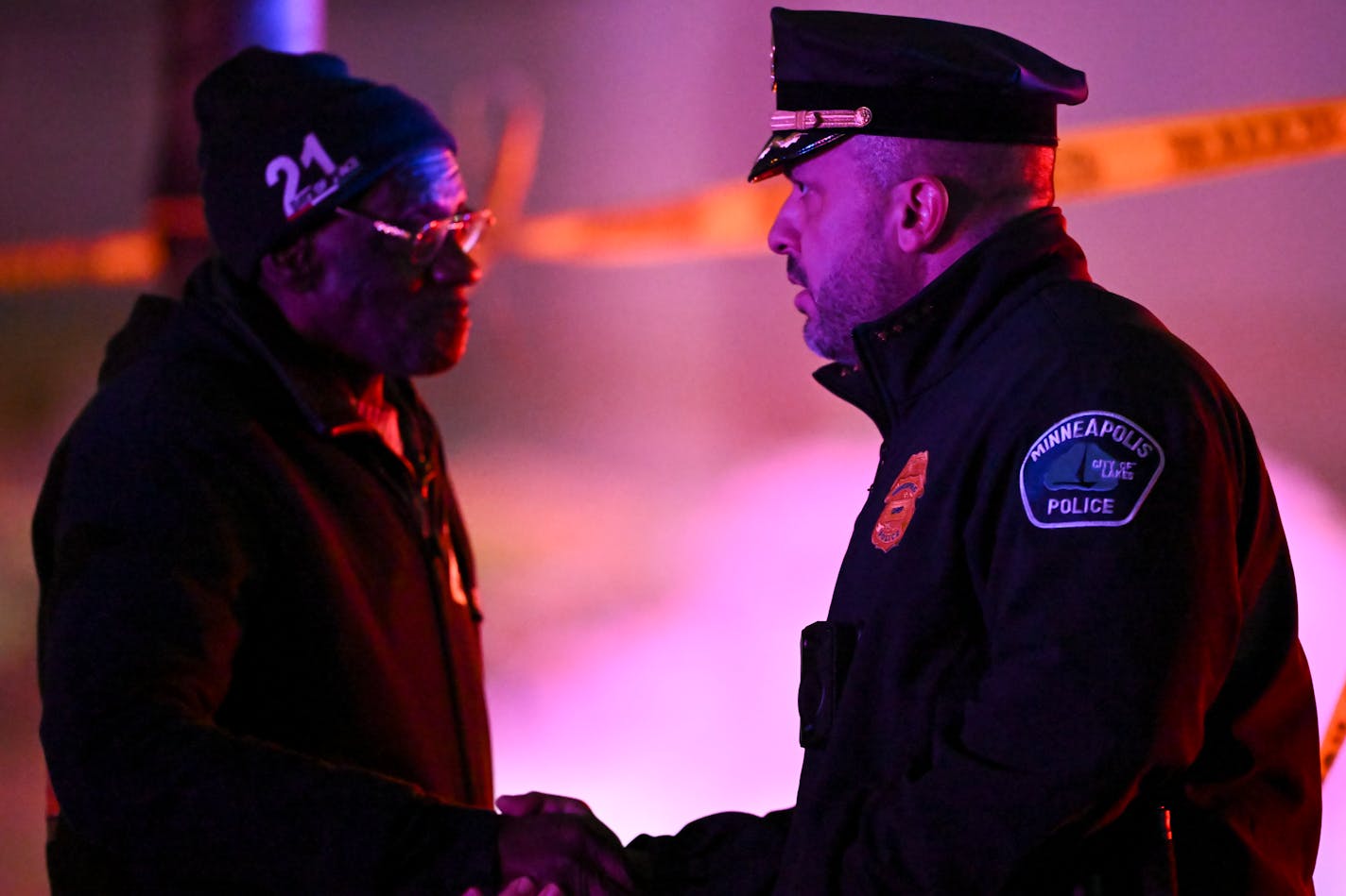 Minneapolis Police Chief Brian O'Hara, right, shook hands with a community member behind the police tape at the scene of a fatal shooting Wednesday, Jan. 11, 2023 near Star Foods on the 800 block of Lowry Avenue North in Minneapolis, Minn.. ] AARON LAVINSKY • aaron.lavinsky@startribune.com