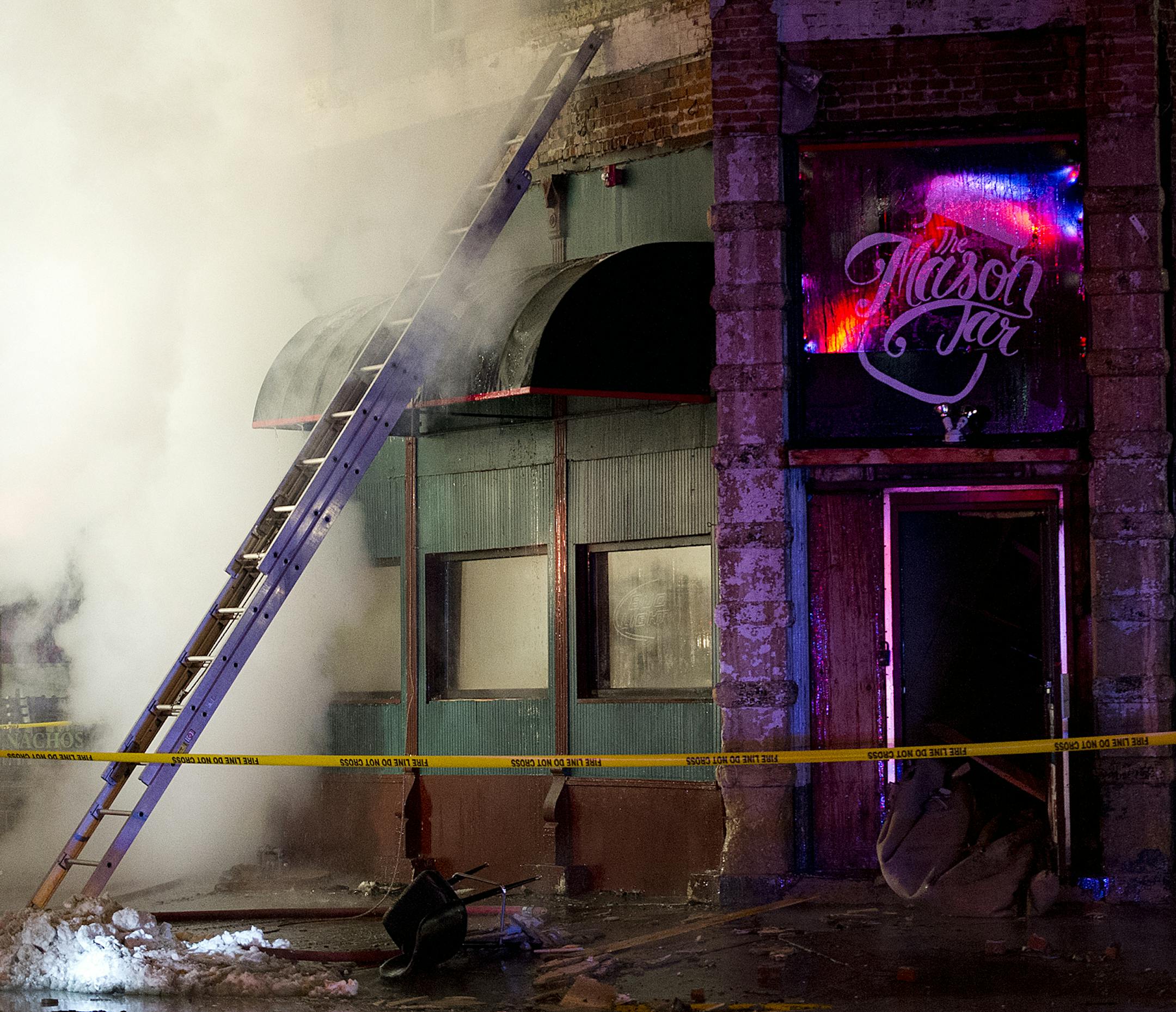 Winona and Goodview firefighters battle a fire at 151 E. Third St. in downtown Winona, Minn., early Friday, Feb. 6, 2015, morning. A bar was on the ground level with seven apartments above it in the building. (AP Photo/Winona Daily News, Andrew Link) ORG XMIT: MIN2015022717222027