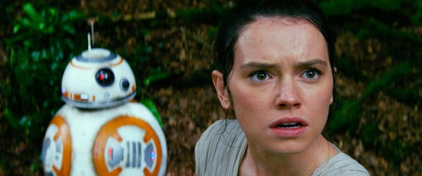 Daisy Ridley stars as Rey, with BB-8, in a scene from "Star Wars: The Force Awakens."