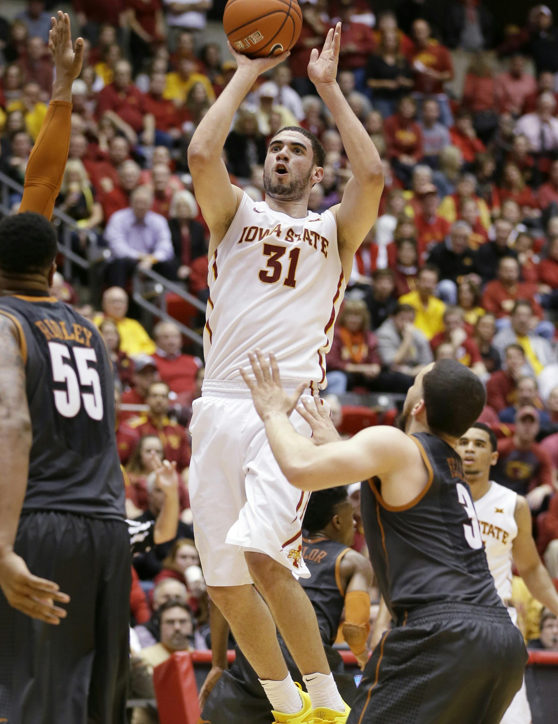 Iowa State forward Georges Niang (31) shoots over Texas guard Javan Felix, right, during the first half of an NCAA college basketball game, Monday, Jan. 26, 2015, in Ames, Iowa. (AP Photo/Charlie Neibergall)