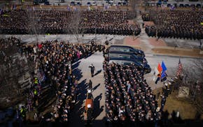 Caskets representing the fallen Burnsville police officers exited the church during a memorial service for Burnsville police officers Paul Elmstrand,