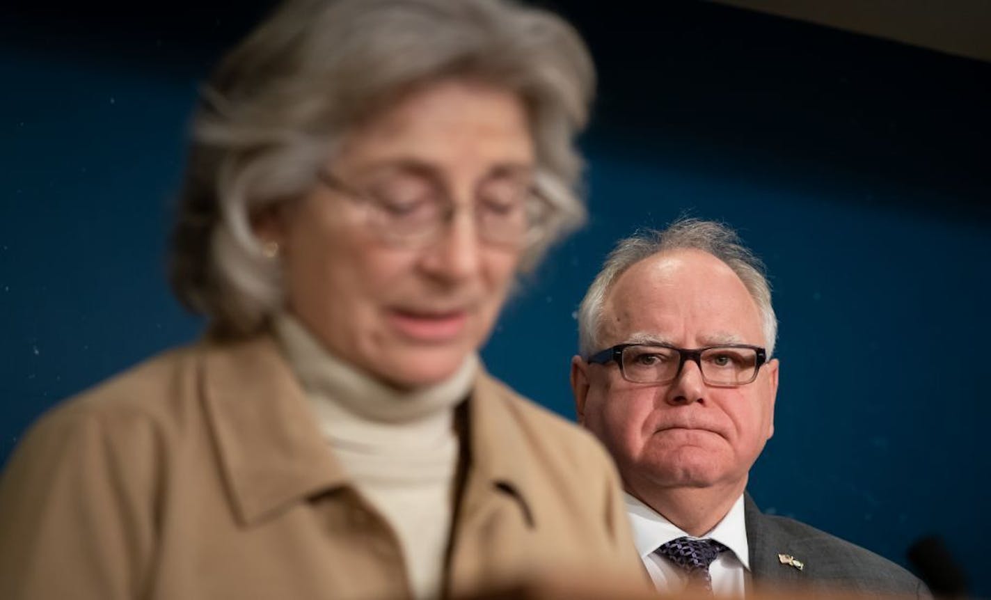 Minnesota Gov. Tim Walz watched as Health Commissioner Jan Malcolm announced community mitigation strategies Friday in response to the COVID-19 pandemic.