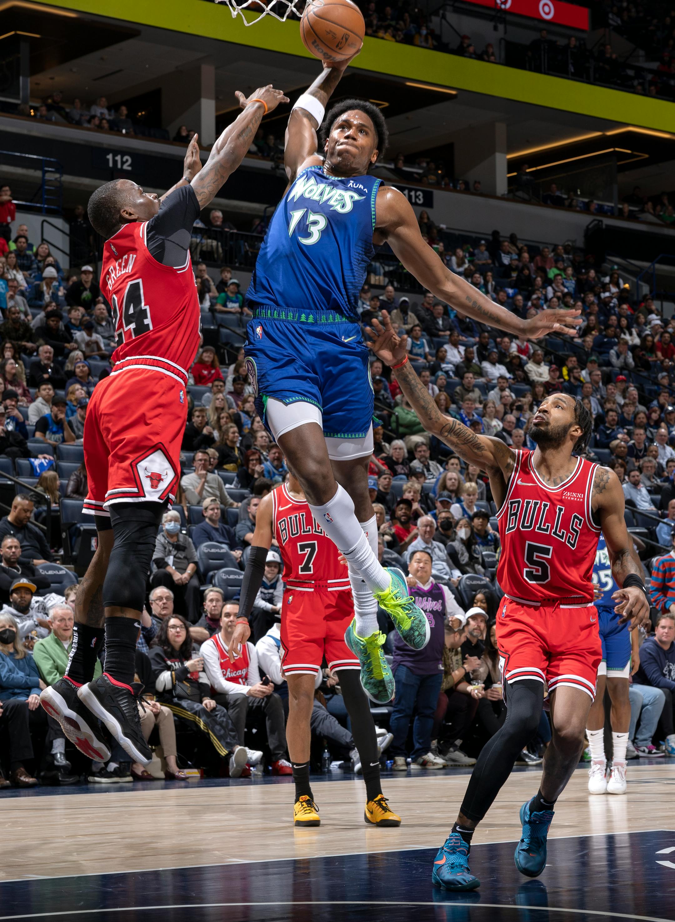Nathan Knight (13) of the Minnesota Timberwolves dunks the ball in the fourth quarter while defended by Javonte Green (24) of the Chicago Bulls.