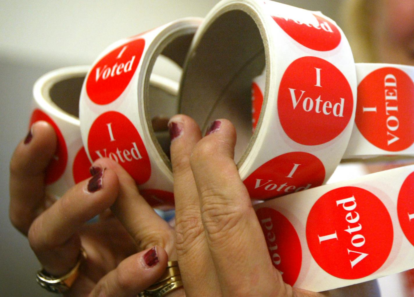 Lori Brown holds a handful of "I voted" stickers that she will organize into supply bins to be delivered to each polling place for the primary elections next week. Brown is a temporary employee who helps out with the elections at the Scott County Government Center. There are 44 precincts Scott County. Stribsouth Ren&#x221a;&#xe0;e Jones/Star Tribune 9/8/04 ORG XMIT: MIN2013100910022654 ORG XMIT: MIN1311051521527862