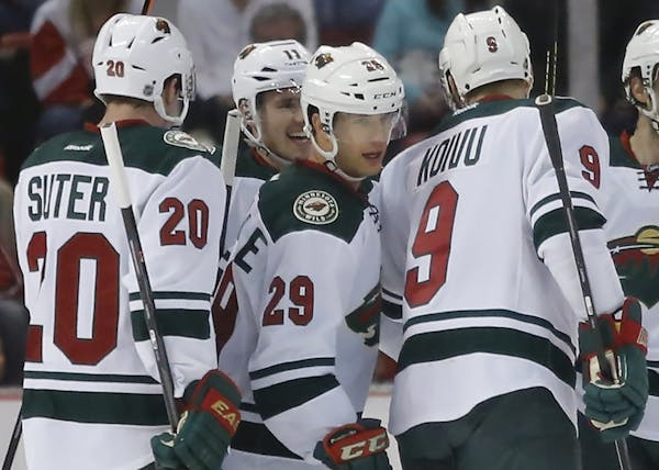 Minnesota Wilds' Jason Pominville (29) celebrates his goal with teammates Ryan Suter (20), Mikko Koivu (9), of Finland, and Zach Parise (11) during th