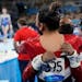 Simone Biles hugged teammate Suni Lee after Biles pulled out of the women’s gymnastic team finals Tuesday in Tokyo. Lee, from St. Paul, assumed the 