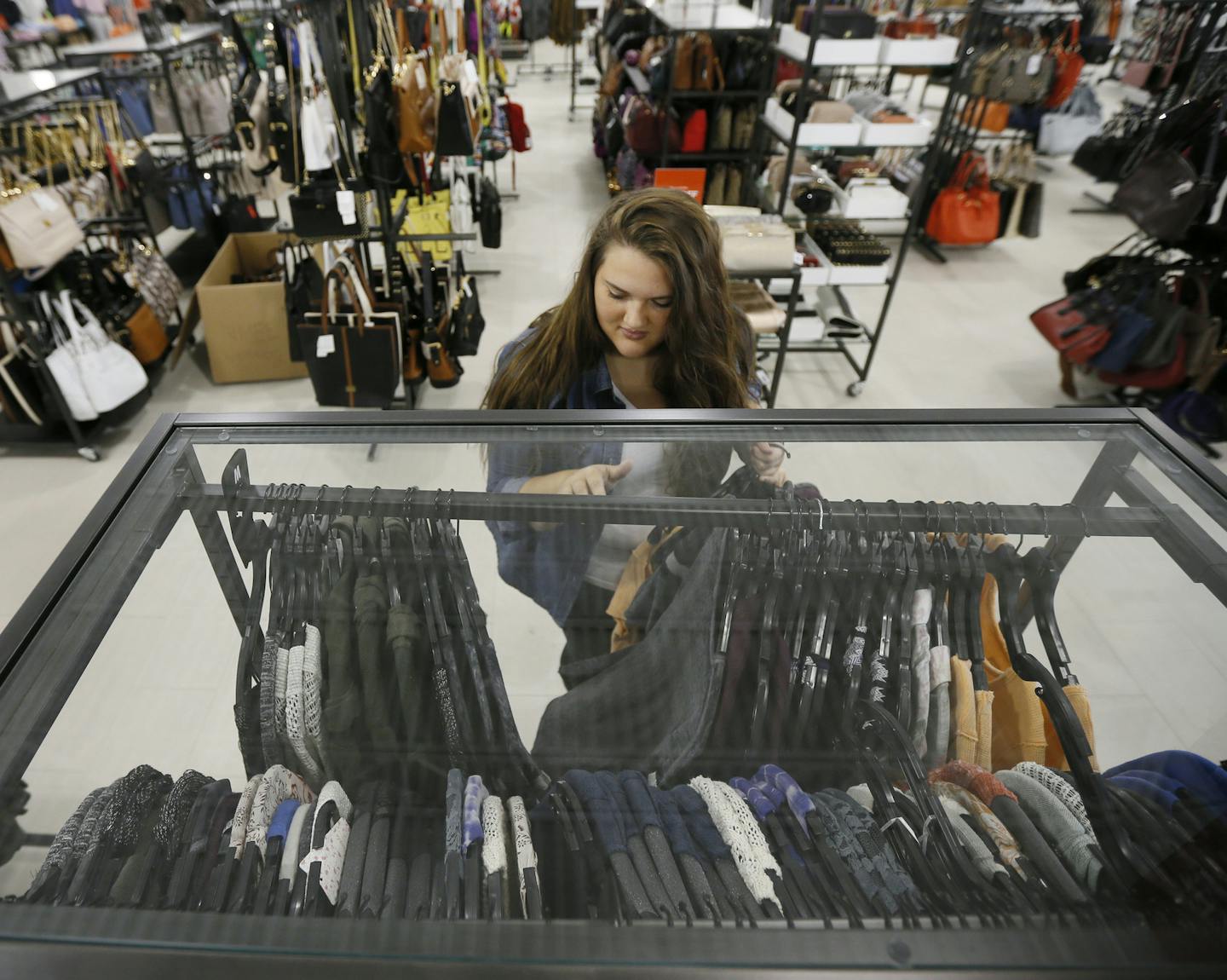 Holly Ring an employee at Saks Fifth Avenue at the new outlet mall in Eagan sorted through clothes Wednesday August 13 , 2014 in Eagan MN . ] Jerry Holt Jerry.holt@startribune.com