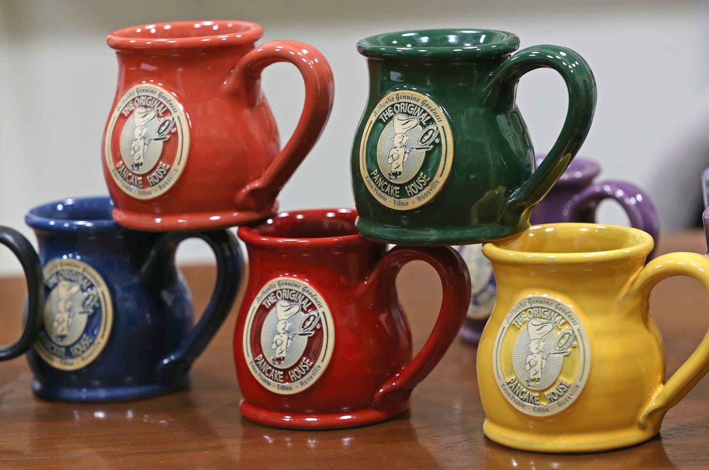 Mugs made by Deneen Pottery, photographed on 4/30/14. Profile on Deneen Pottery, a small St. Paul company that makes custom stoneware and coffee mugs the old-fashioned way, by tossing a lump of clay on a potter's wheel. The company is growing by leaps and bounds, doubling its number of employees to more than 50 over the last couple of years. They even have a dog wandering the factory and shop.] Bruce Bisping/Star Tribune bbisping@stribune