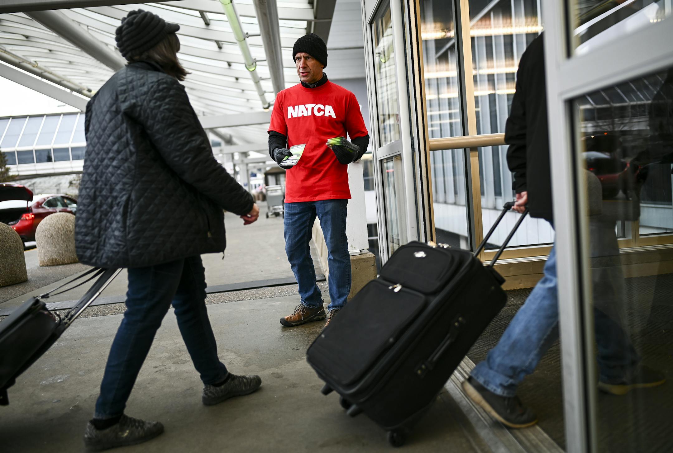 Roger Mathieu, a retired air traffic controller of 36 years, handed out pamphlets to travelers arriving Tuesday outside Terminal 1 at Minneapolis-St. Paul International Airport. ] Aaron Lavinsky &#xa5; aaron.lavinsky@startribune.com TSA operations at MSP Airport seem to be relatively normal for travelers, despite the government shutdown. We photograph TSA operations Tuesday, Jan. 15, 2019 at Minneapolis-St. Paul International Airport.