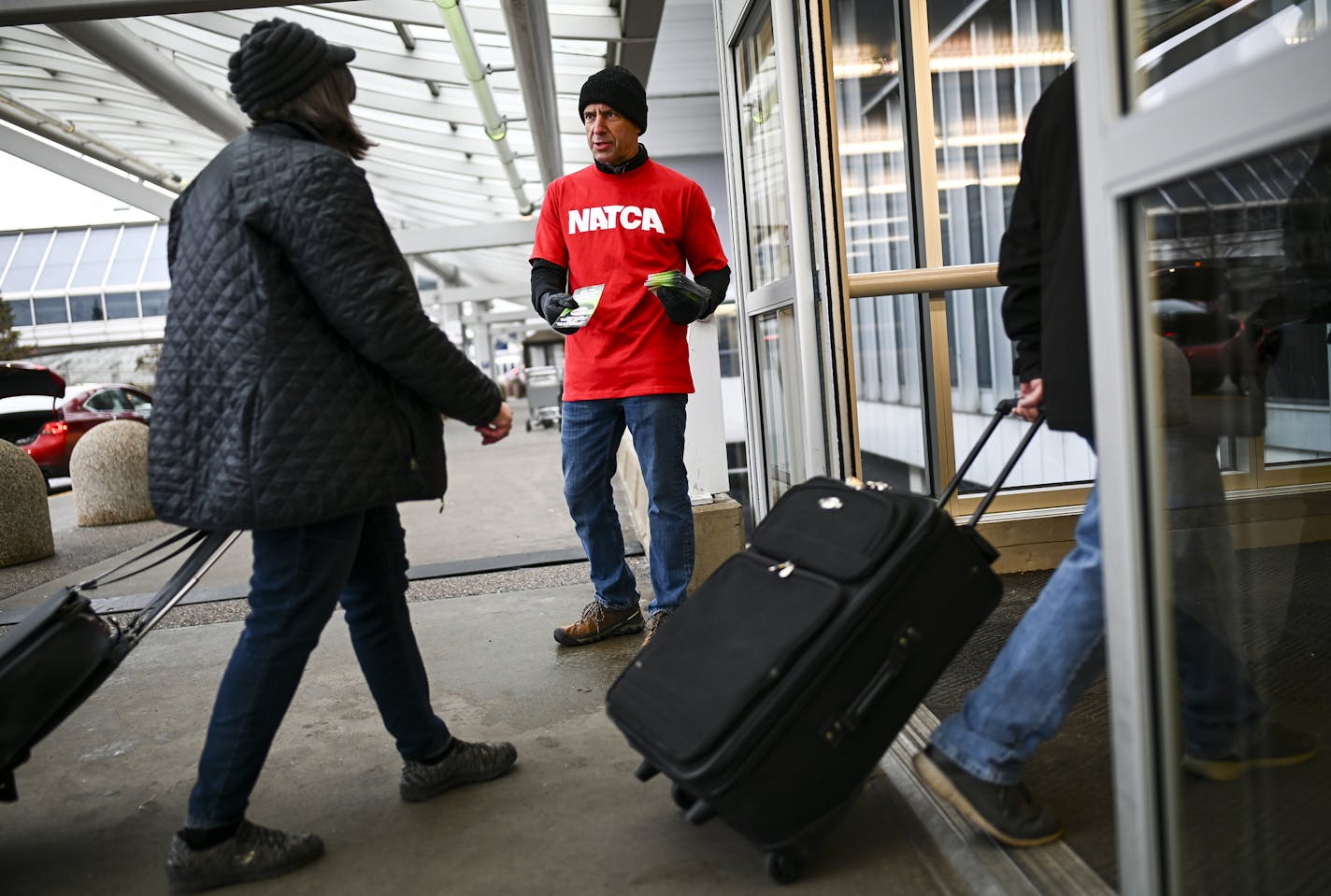 Roger Mathieu, a retired air traffic controller of 36 years, handed out pamphlets to travelers arriving Tuesday outside Terminal 1 at Minneapolis-St. Paul International Airport. ] Aaron Lavinsky &#xa5; aaron.lavinsky@startribune.com TSA operations at MSP Airport seem to be relatively normal for travelers, despite the government shutdown. We photograph TSA operations Tuesday, Jan. 15, 2019 at Minneapolis-St. Paul International Airport.