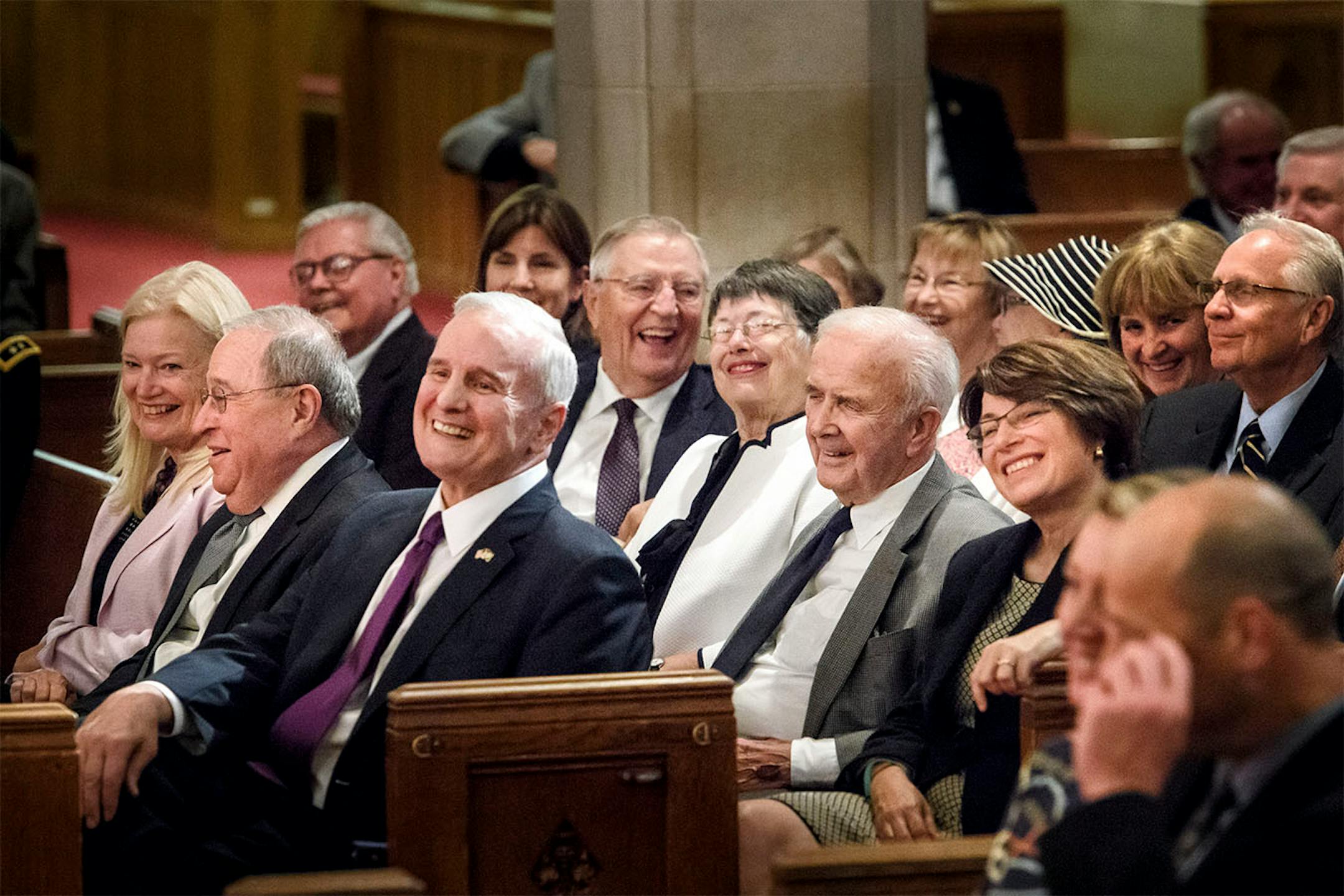 Dignitaries and friends of Former Gov. Wendell Anderson laughed as former Senate Majority Leader Roger Moe talked about Anderson. L to R are Randy and David Lebedoff, Governor Mark Dayton, Vice President Walter Mondale, Marge and Warren Spannaus, Senator Amy Klobuchar, Former Governor Arne Carlson.