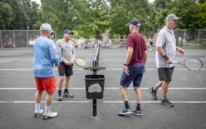 From left, Ben Streitz, Don Combs, Charles Weed, and David Carberry with the Minneapolis Community Clay Courts nonprofit group, gather to play tennis