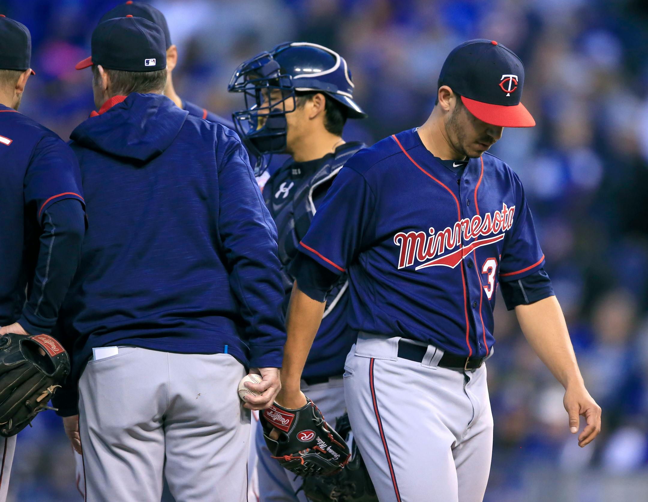 Minnesota Twins starting pitcher Tommy Milone, right, is relieved during the fifth inning of a baseball game against the Kansas City Royals at Kauffman Stadium in Kansas City, Mo., Saturday, April 9, 2016. (AP Photo/Orlin Wagner)
