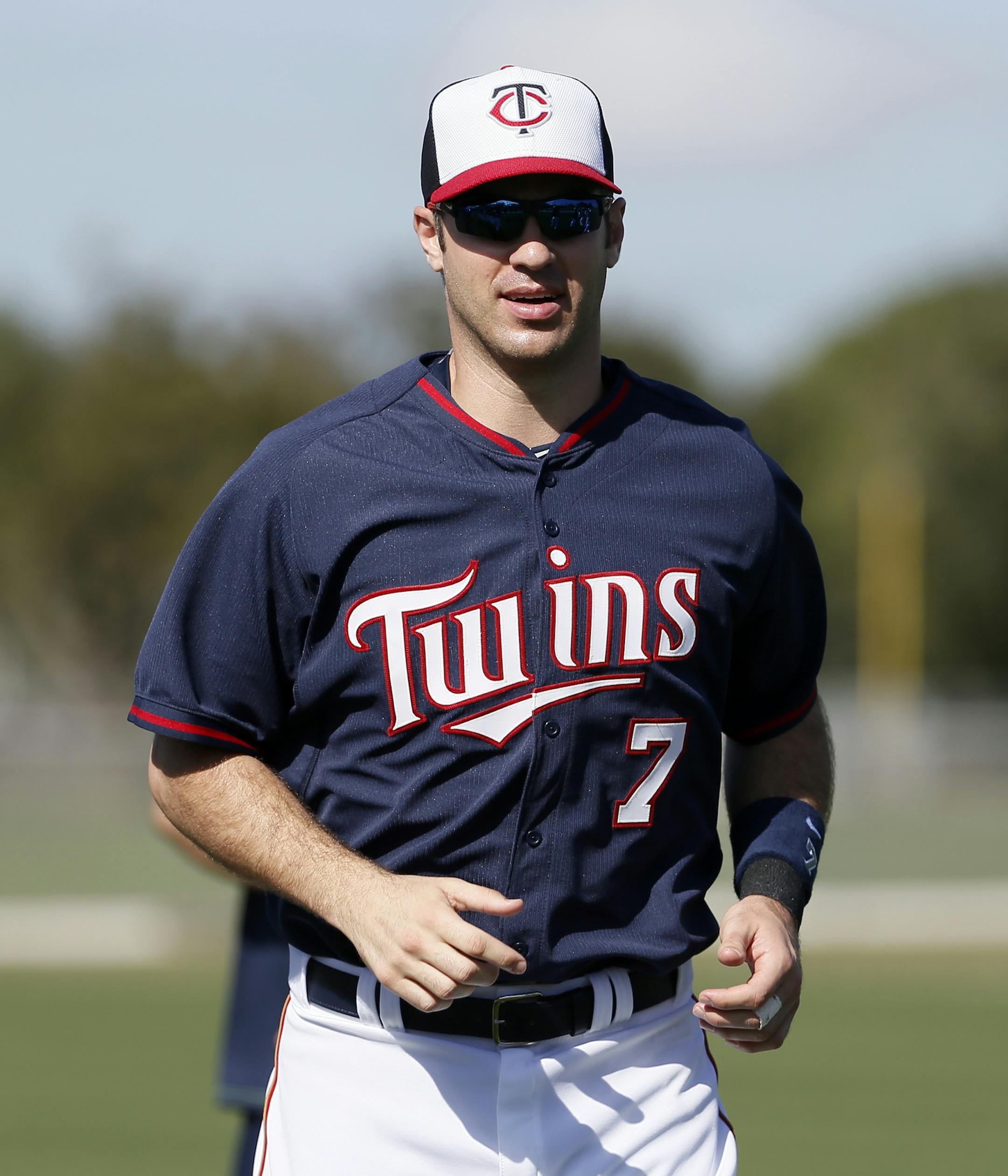 Minnesota Twins first baseman Joe Mauer (7) jogs as he warms up with teammates before a workout at baseball spring training in Fort Myers, Fla., Tuesday March 3, 2015. (AP Photo/Tony Gutierrez)