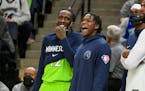 Minnesota Timberwolves guard Anthony Edwards, right, and forward Taurean Prince enjoy the final minutes of their game as they defeat the Memphis Grizz