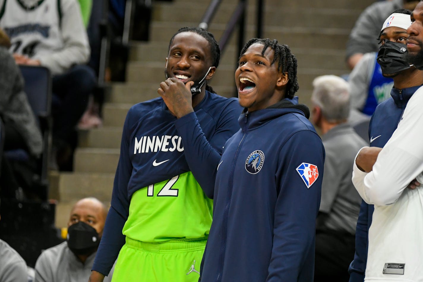 Minnesota Timberwolves guard Anthony Edwards, right, and forward Taurean Prince enjoy the final minutes of their game as they defeat the Memphis Grizzlies 138-95 during an NBA basketball game Saturday, Nov. 20, 2021, in Minneapolis. (AP Photo/Craig Lassig)