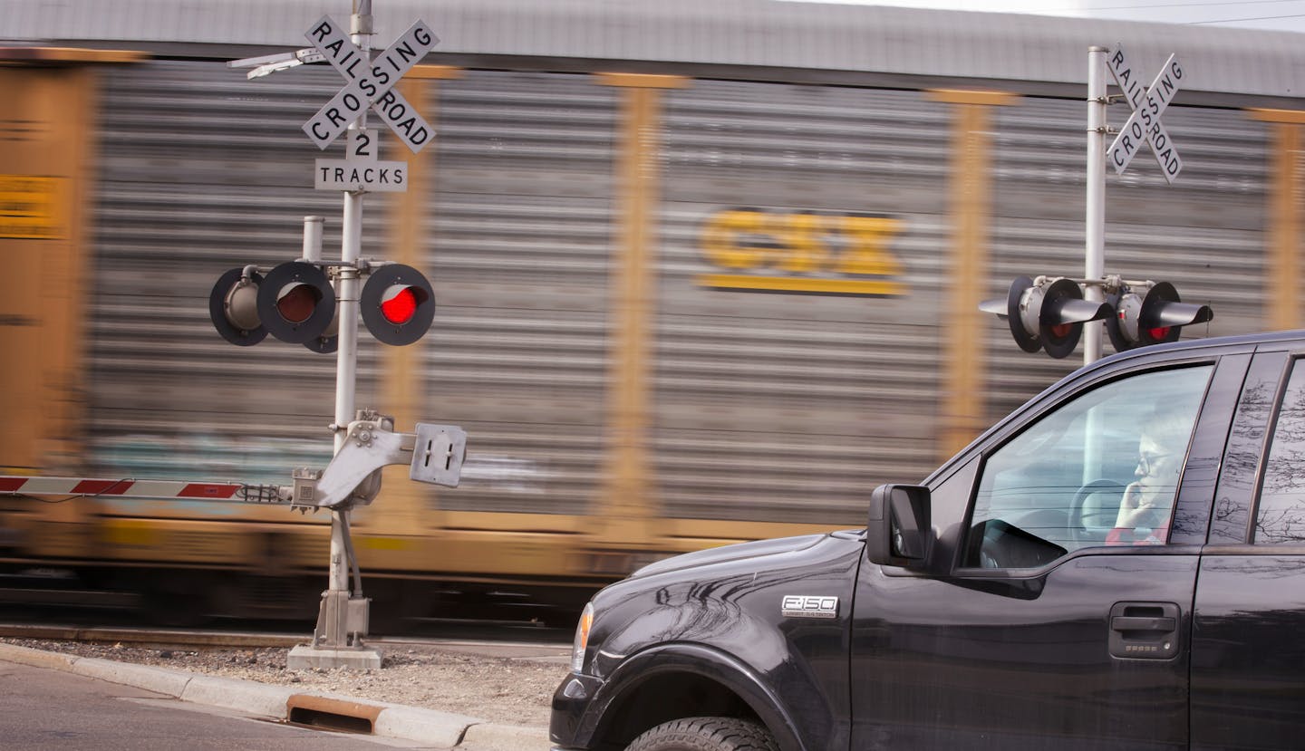 Cars wait at the rail crossing at Como Avenue south of Lake Como in St. Paul on Tuesday, April 21, 2015. ] LEILA NAVIDI leila.navidi@startribune.com / BACKGROUND INFORMATION: A report by the MnDOT said more than $300 million was needed to improve rail crossings across the state used by trains hauling oil from North Dakota. The report, released late last year, said one of the highest-risk areas include twin road crossings southeast of Como Lake in St. Paul. Last year, he said, there were 47 train