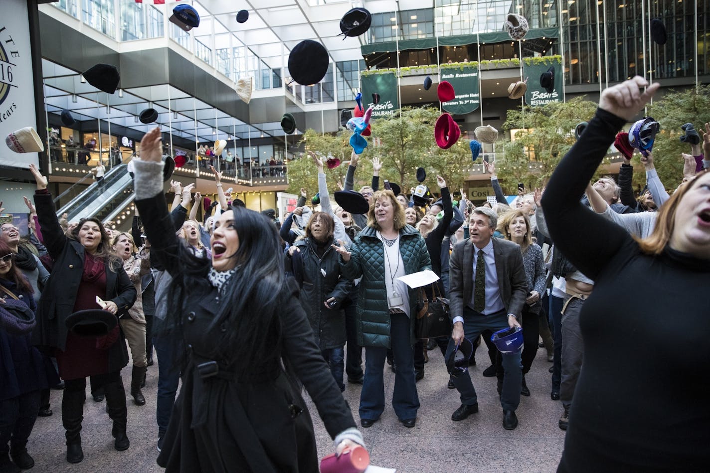 A crowd of people gathered to sing the Mary Tyler Moore Show theme song and throw their hats in the air in remembrance of Mary Tyler Moore after her passing this week, in the IDS Crystal Court in downtown Minneapolis, Minn., on Friday, January 27, 2016. In foreground left is musician Kat Perkins who led the group.