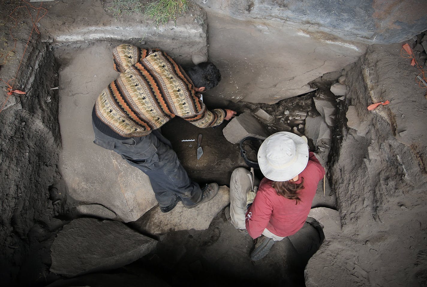 This undated image provided by journal Science shows Kurt Rademaker and Sonia Zarrillo during excavations at Cuncaicha rock shelter in the Peruvian Andes. Stone tools and other artifacts have revealed the presence of hunter-gatherers at about 14,700 feet above sea level, between 12,000 and 12,500 years ago in the Peruvian Andes. (AP Photo/Science, Walter Beckwith)