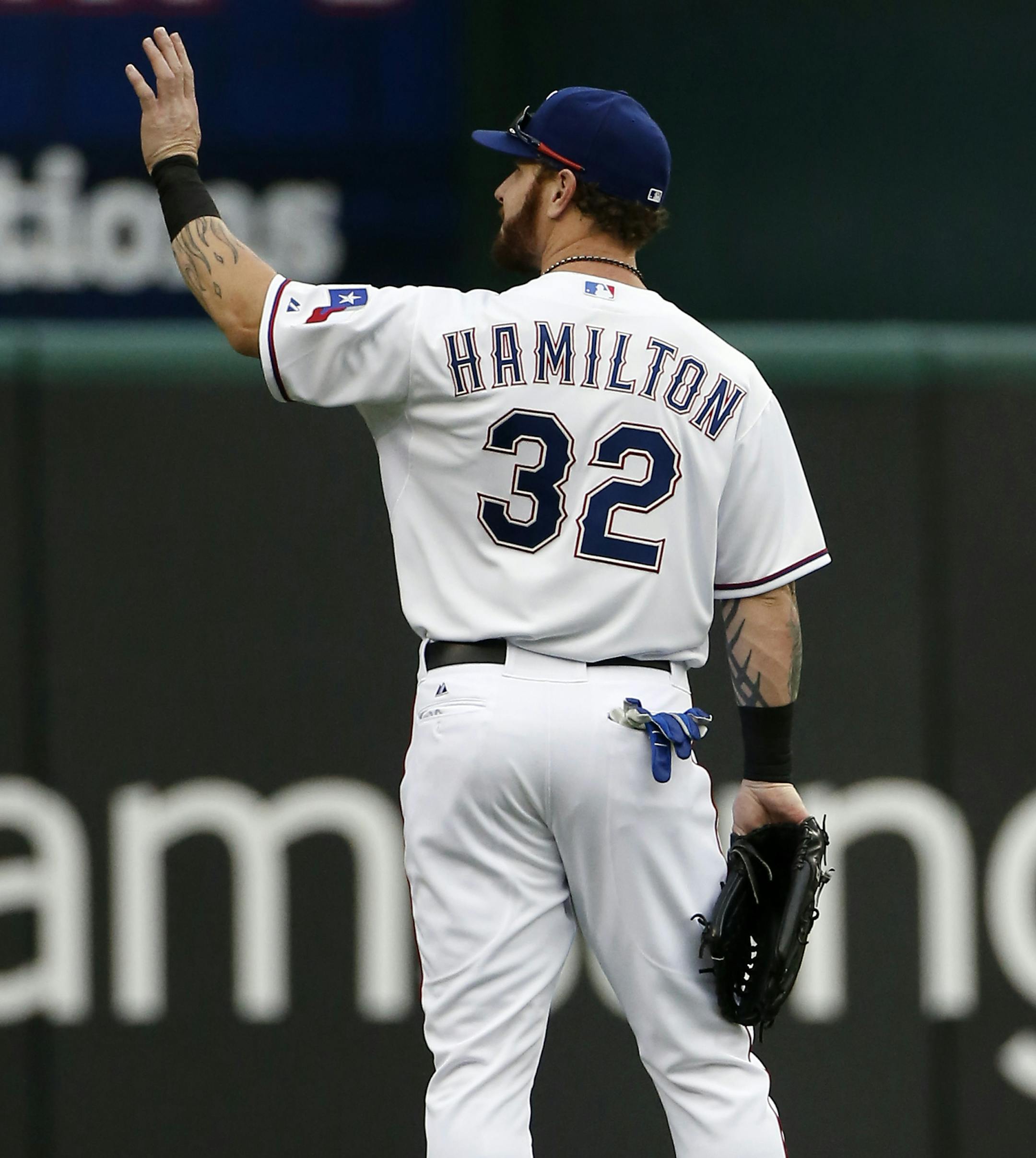 Texas Rangers left fielder Josh Hamilton (32) waves to fans after running out onto the field at the start of the first inning of a baseball game against the Boston Red Sox, Thursday, May 28, 2015, in Arlington, Texas. The game is Hamilton's first at home since being acquired from the Los Angeles Angels. (AP Photo/Brandon Wade)