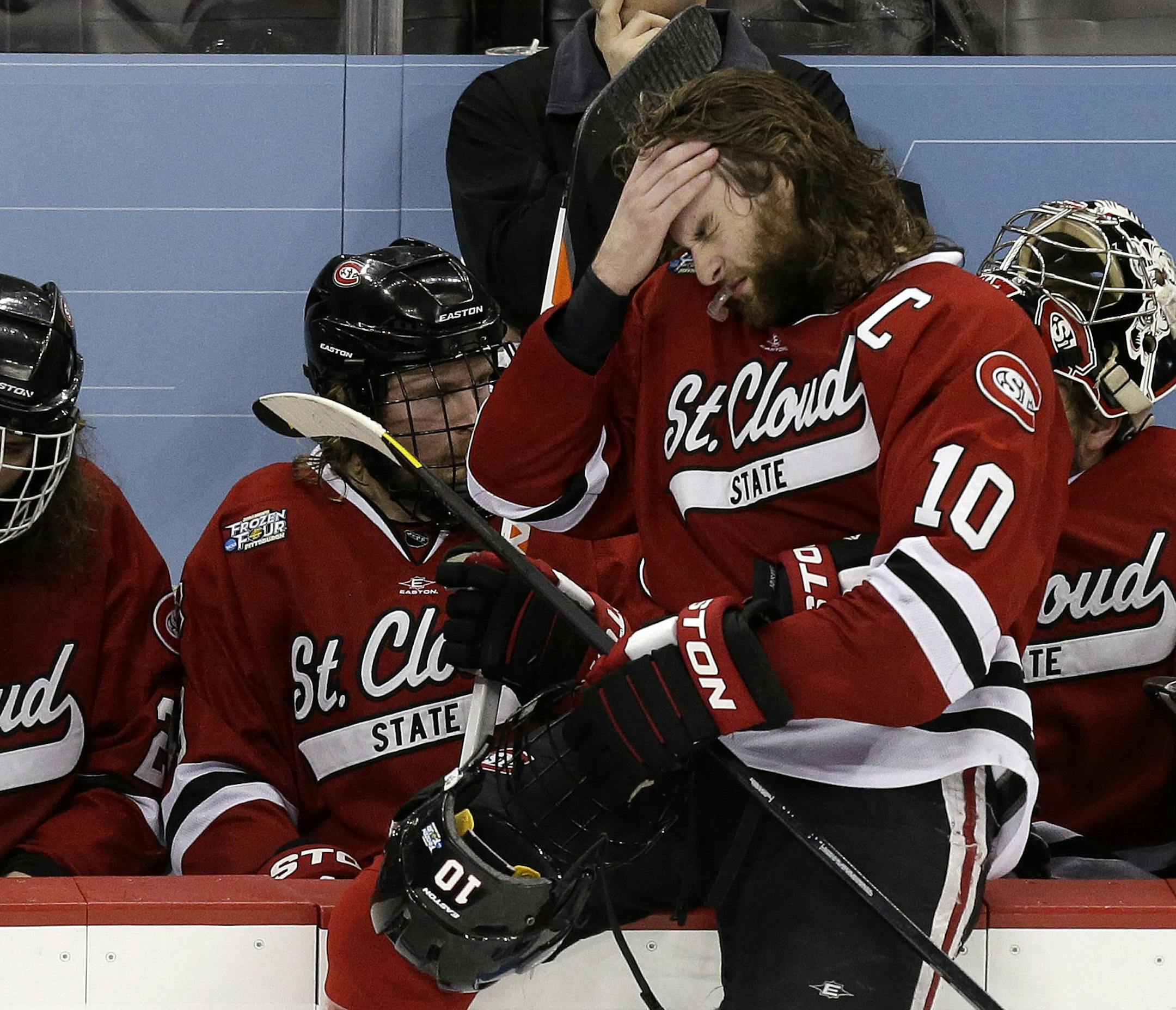 St. Cloud State captain Ben Hanowski (10) sits on the boards in front of his bench during a third-period timeout during an NCAA college hockey Frozen Four semifinal game against Quinnipiac in Pittsburgh, Thursday, April 11, 2013. Quinnipiac won 4-1. Quinnipaic advances to the national championship game Saturday against Yale. (AP Photo/Gene J. Puskar)