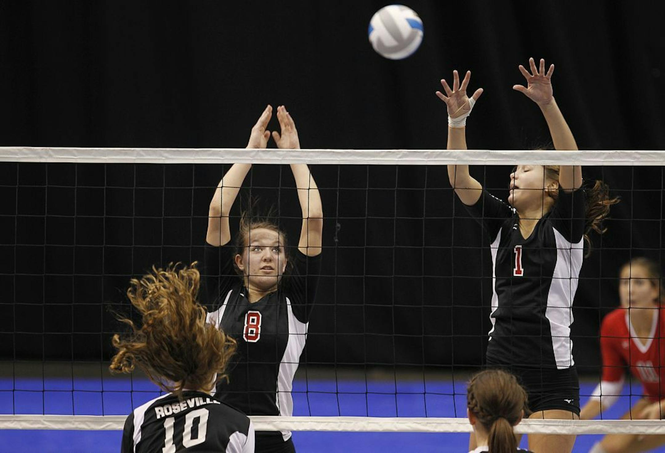 Shakopee's Mackenzie Pieper, left, and Tina Hoppe took to the net against Roseville