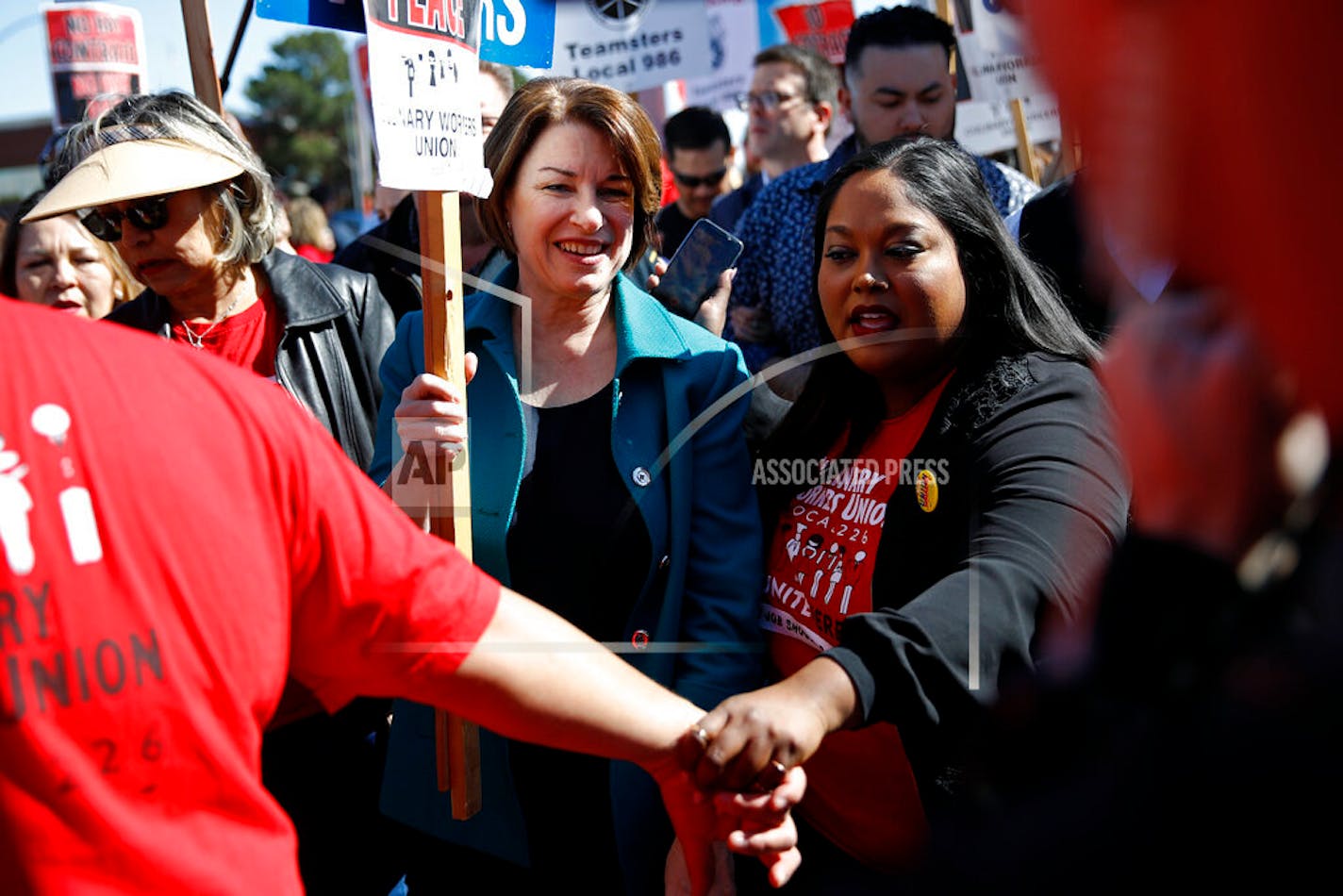 Democratic presidential candidate Sen. Amy Klobuchar, D-Minn., walks on a picket line with members of the Culinary Workers Union Local 226 outside the Palms Casino in Las Vegas on Wednesday.