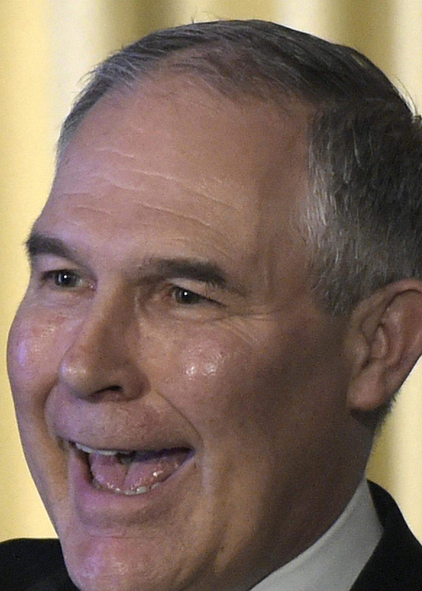 Environmental Protection Agency (EPA) Administrator Scott Pruitt holds up a hat that was presented to him before speaking to employees of the EPA in Washington, Tuesday, Feb. 21, 2017. (AP Photo/Susan Walsh)