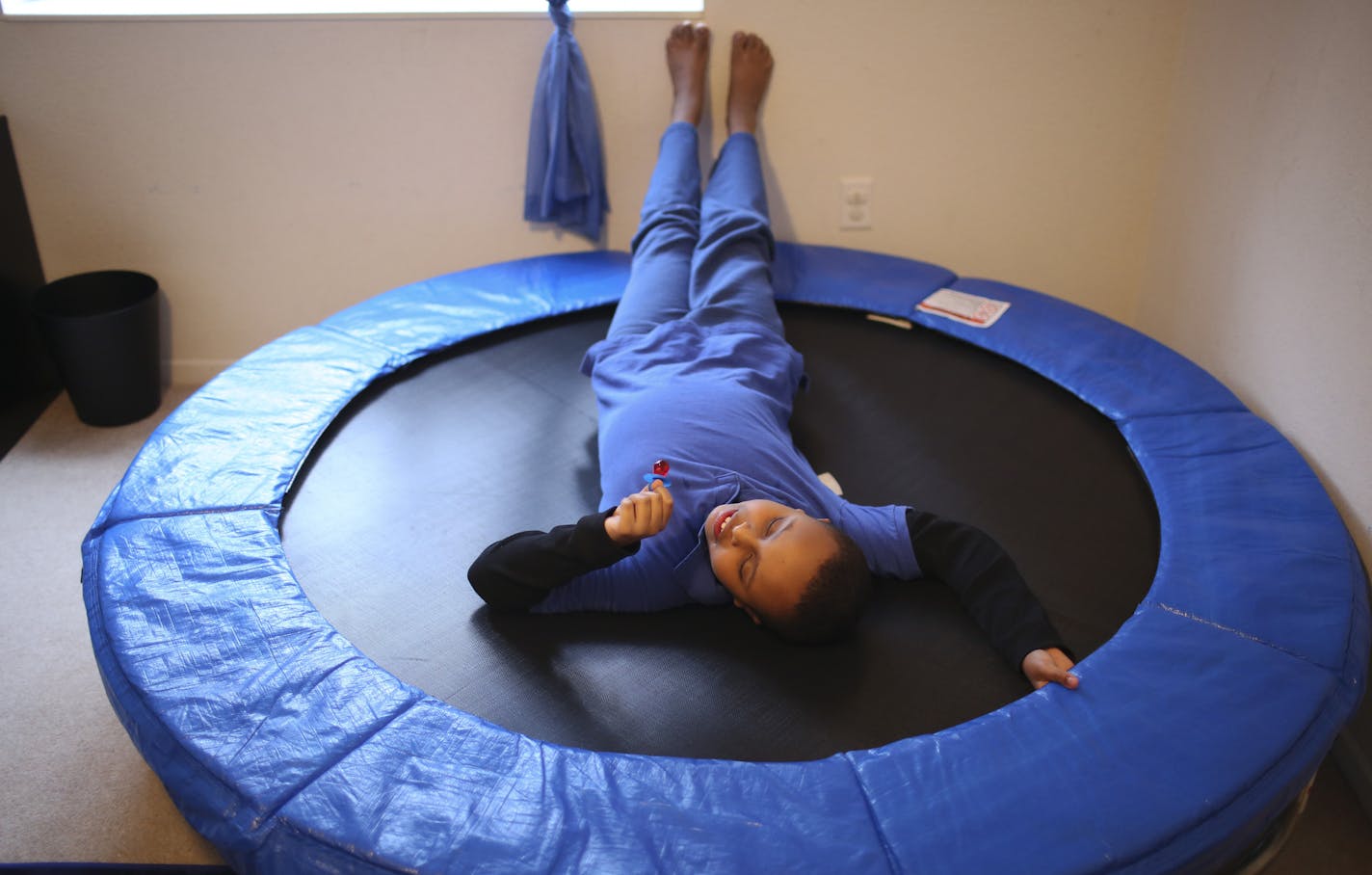 A University of Minnesota study released Monday, December 16, 2013, has found elevated rates of Autism among children who are white or Somali in the Twin Cities when compared to black or Hispanic youngsters. Idil Abdull's Eleven year-old son, Abdullahi, rested on the trampoline in his therapy room at their home in Savage Monday afternoon, December 16, 2013. Abdullahi, who has been diagnosed with Autism, stopped at home for a snack before heading to a therapy appointment. ] JEFF WHEELER &#x201a;&