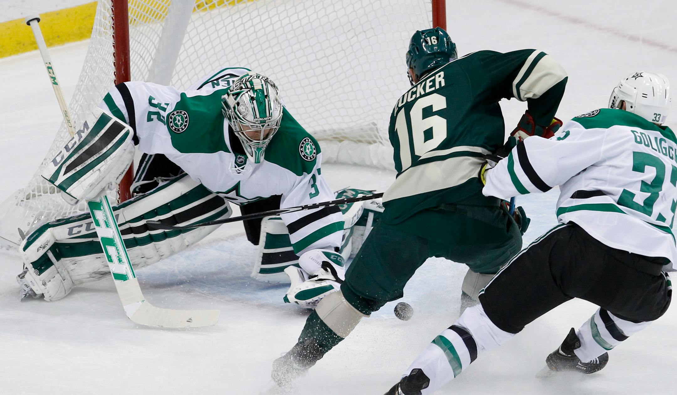 Dallas Stars goalie Kari Lehtonen (32), of Finland, deflects a shot by Minnesota Wild left wing Jason Zucker (16) in front of Stars defenseman Alex Goligoski (33) during the first period of an NHL hockey game in St. Paul, Minn., Saturday, Nov. 1, 2014. (AP Photo/Ann Heisenfelt)