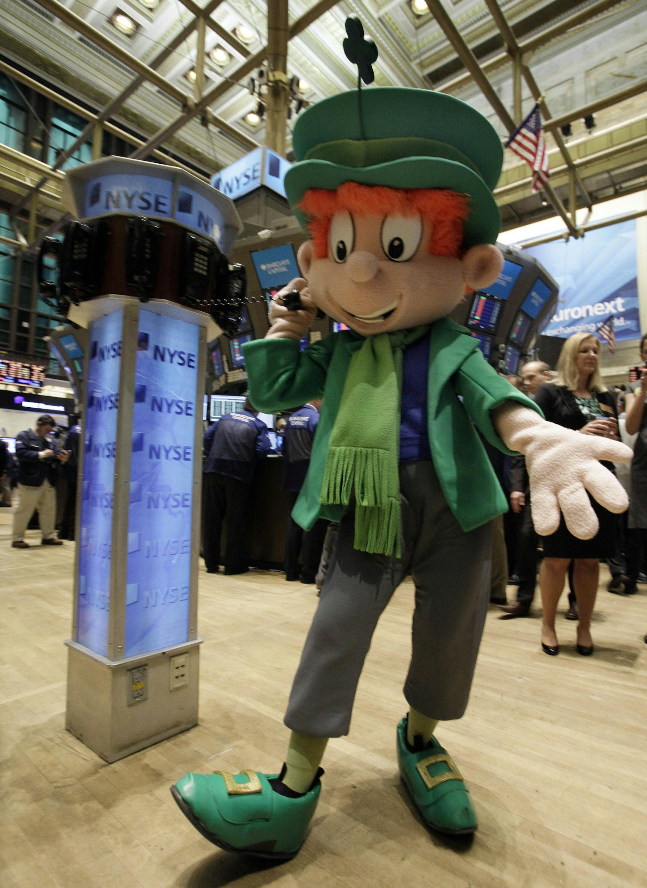 The General Mills cereal mascot for Lucky Charms poses for photos on the trading floor of the New York Stock Exchange before ringing the opening bell, Thursday, March 17, 2011. (AP Photo)