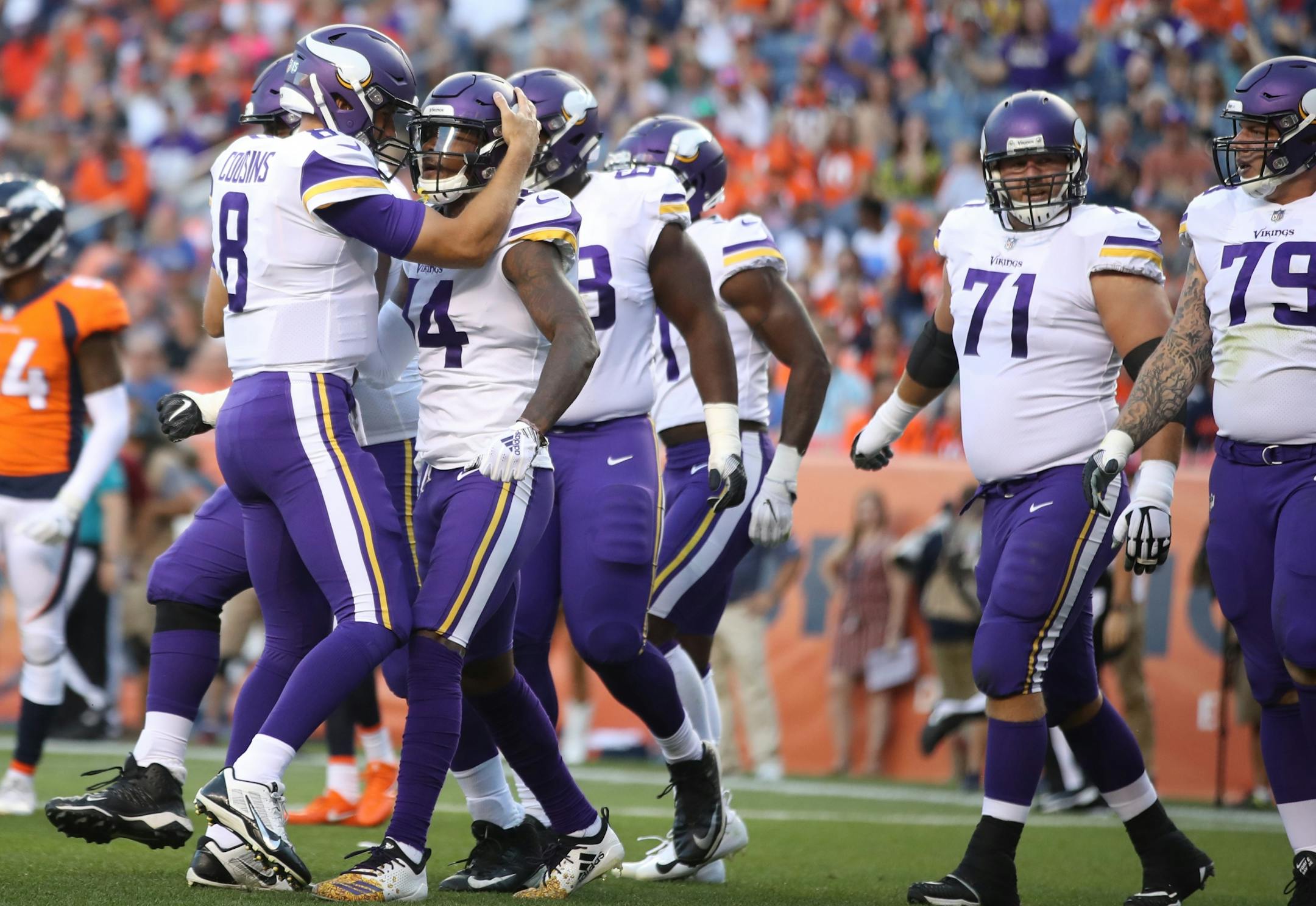 Minnesota Vikings quarterback Kirk Cousins (8) celebrated his short first down touchdown pass to Minnesota Vikings wide receiver Stefon Diggs (14)Saturday August 11, 2018 at Mile High Stadium in Denver, CO.